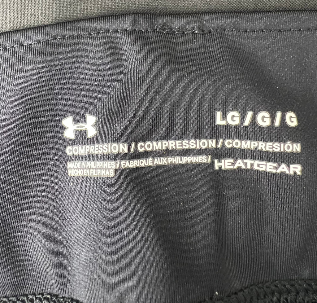 Close-up of Inside label showing Under Armour logo, size Large, Compression fit and HeatGear fabric technology
