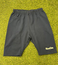 Front view of navy blue KooGa fleece lined rugby shorts on grass surface