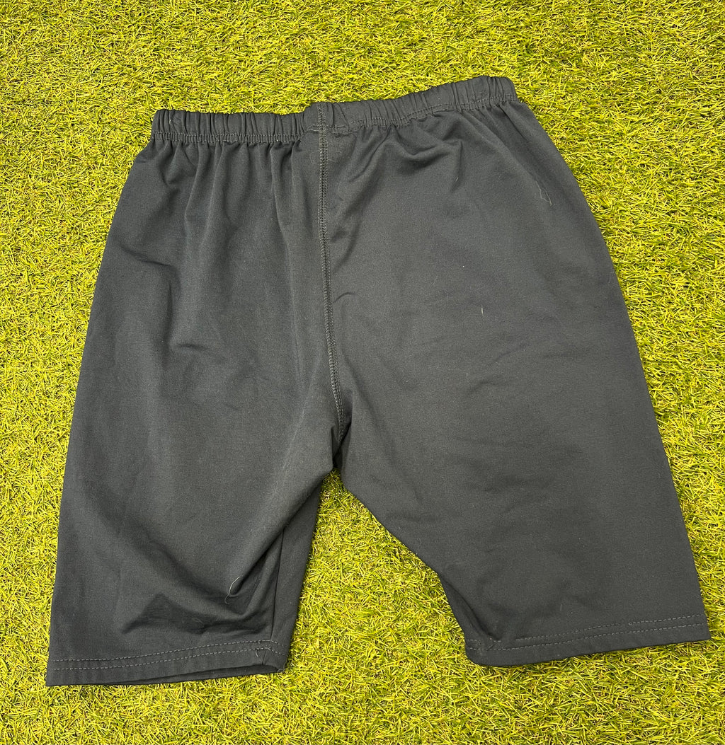 Back view of navy blue KooGa fleece lined rugby shorts on grass surface