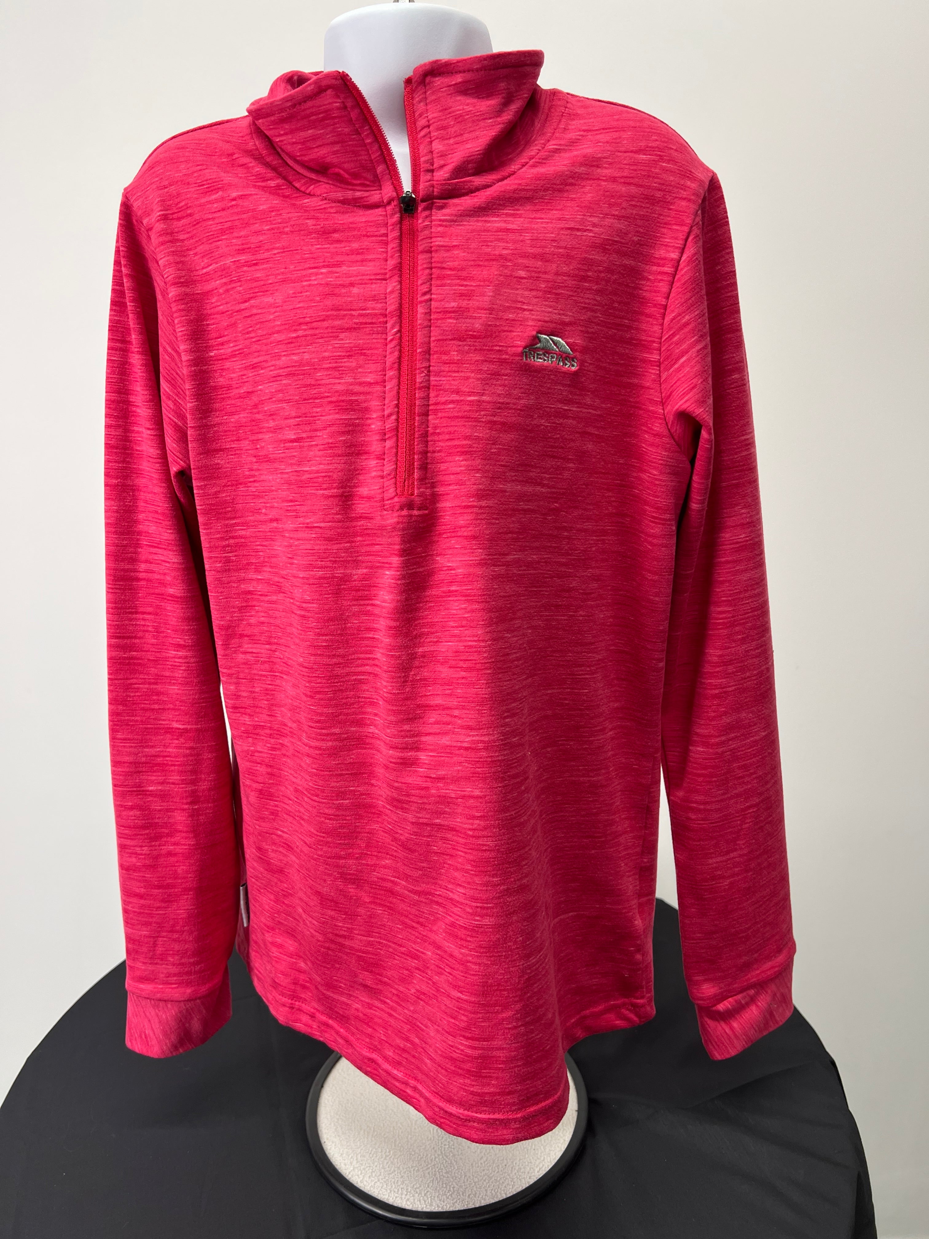 Front view of pink kids Trespass 1/2 zip base layer top on mannequin