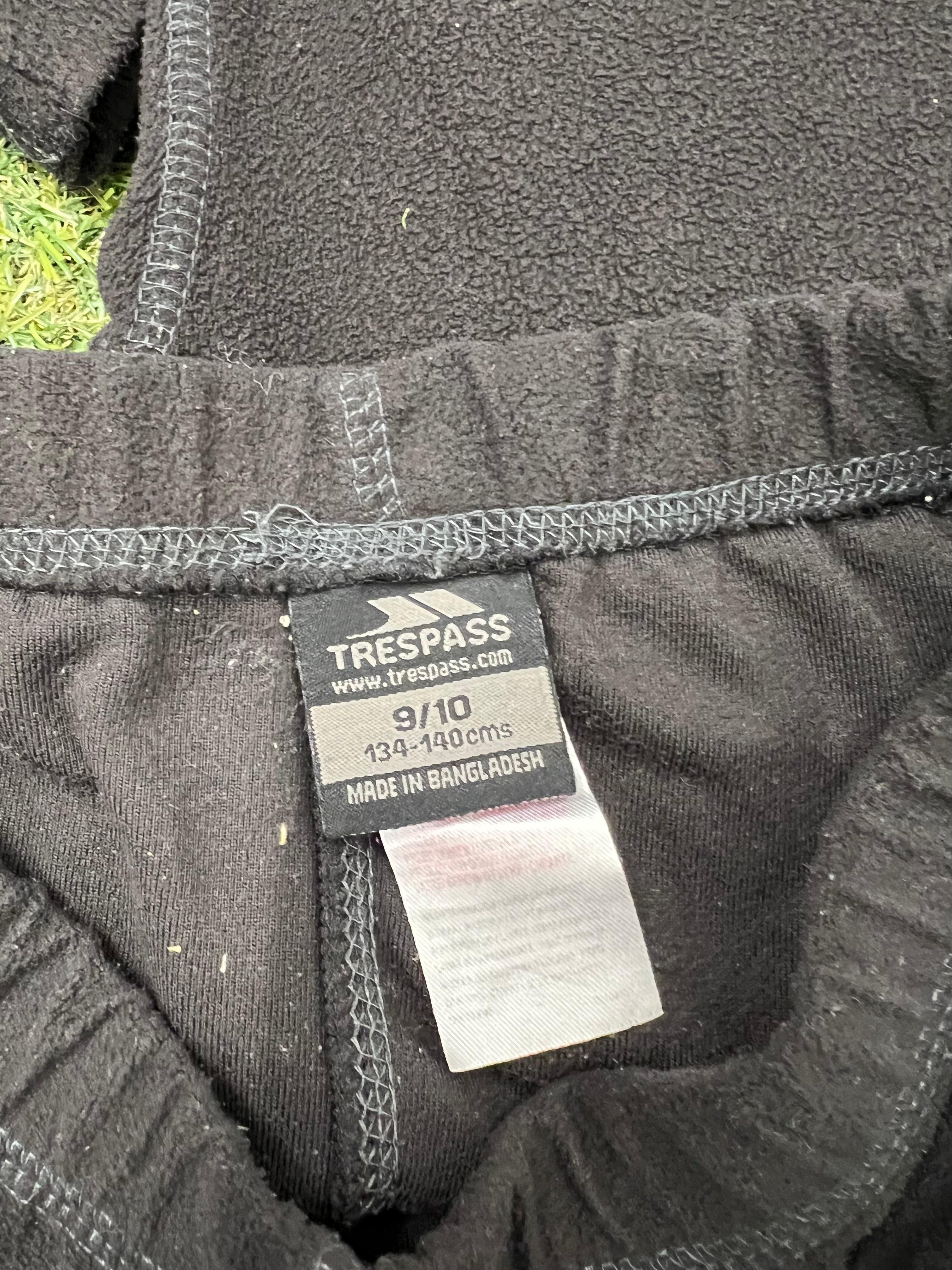 Close-up of Trespass brand label inside black fleece leggings showing size 9-10 and fabric details
