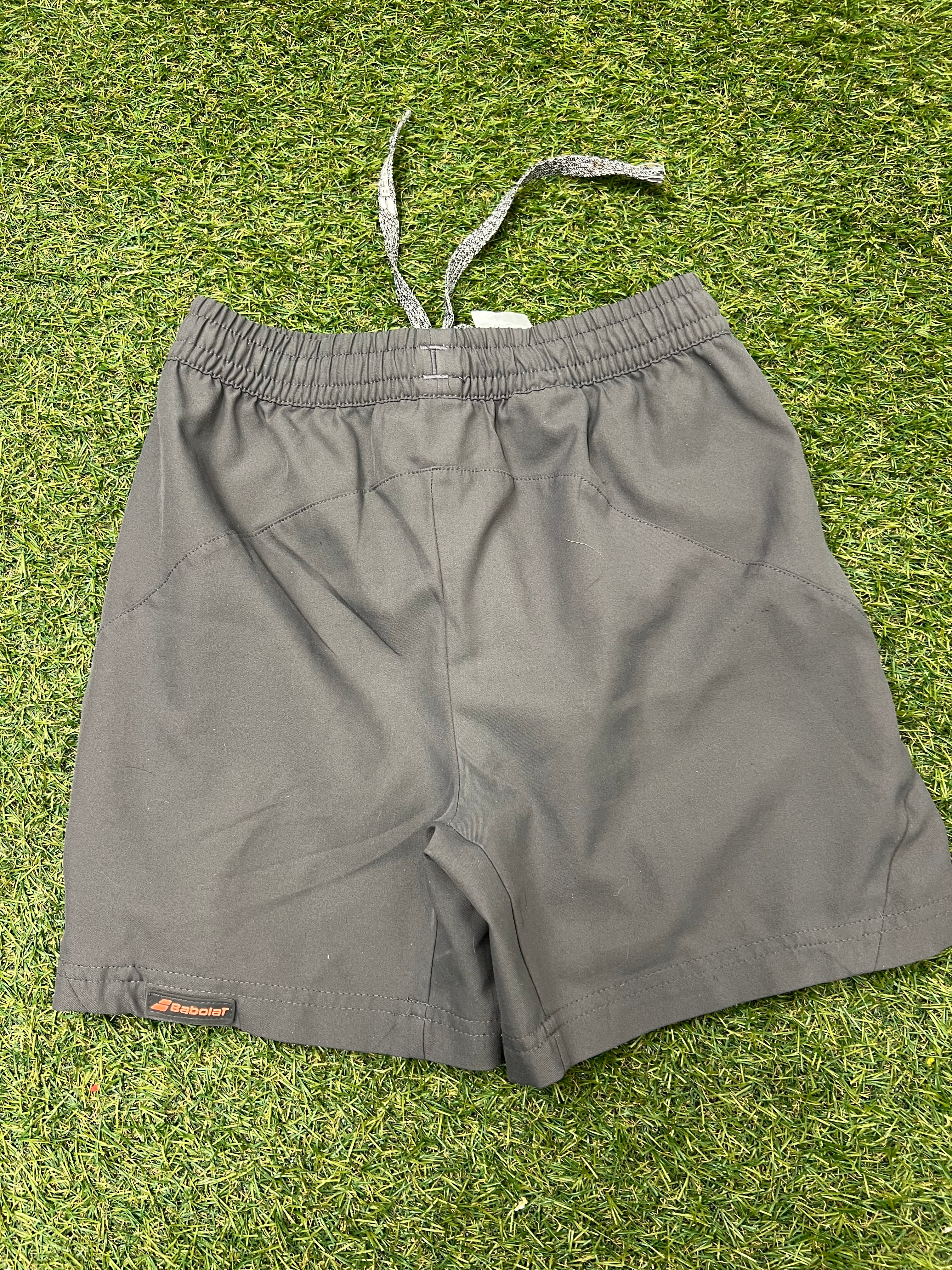 Back view of grey Babolat kids training shorts showing elastic waistband