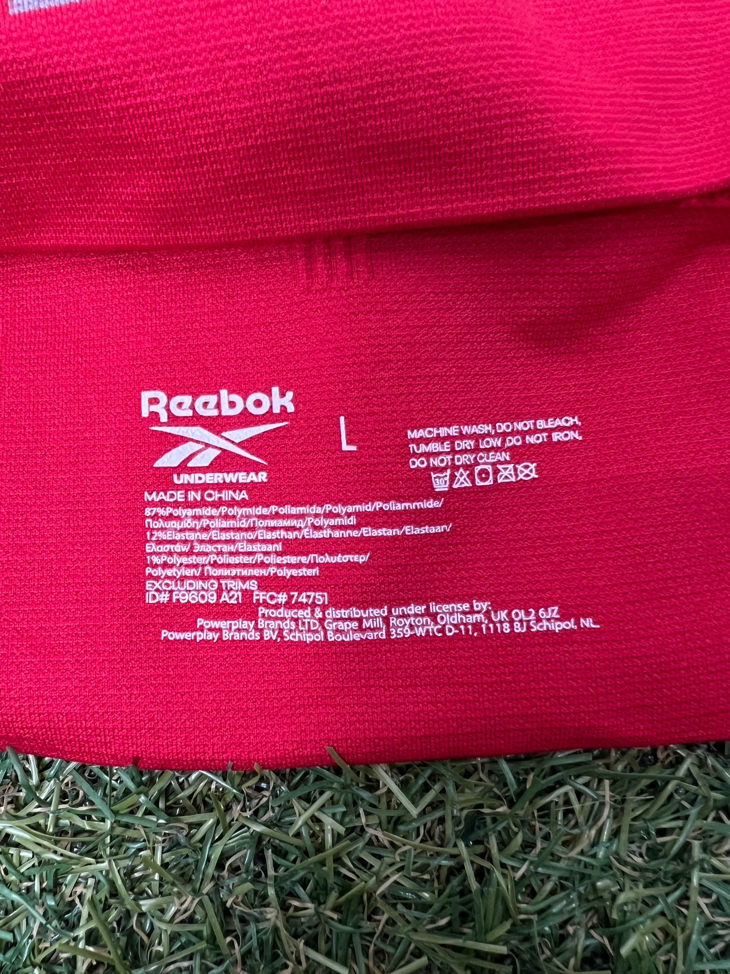Close-up of Reebok sports bra fabric label with size L and care instructions