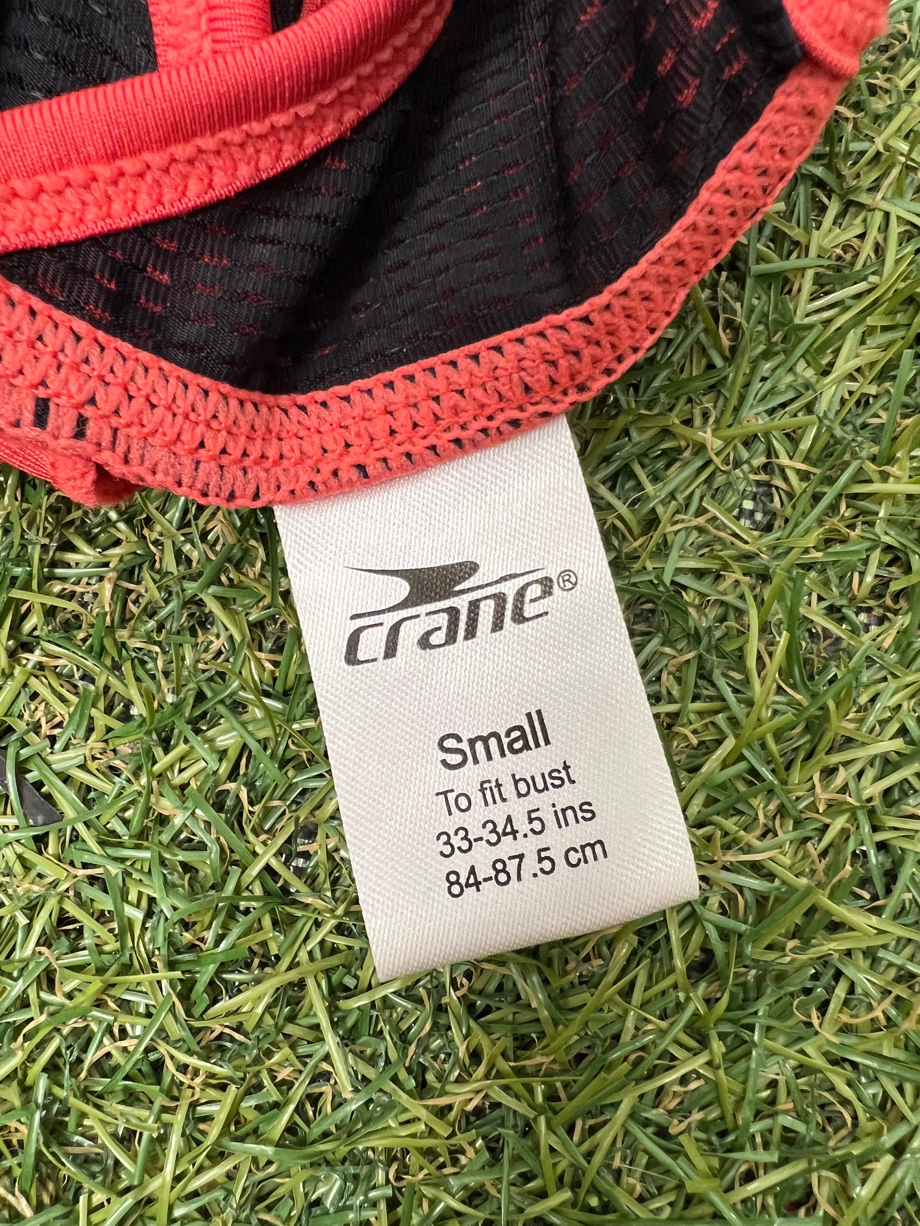 Close-up of Crane brand tag showing size small and bust fitting details on sports bra