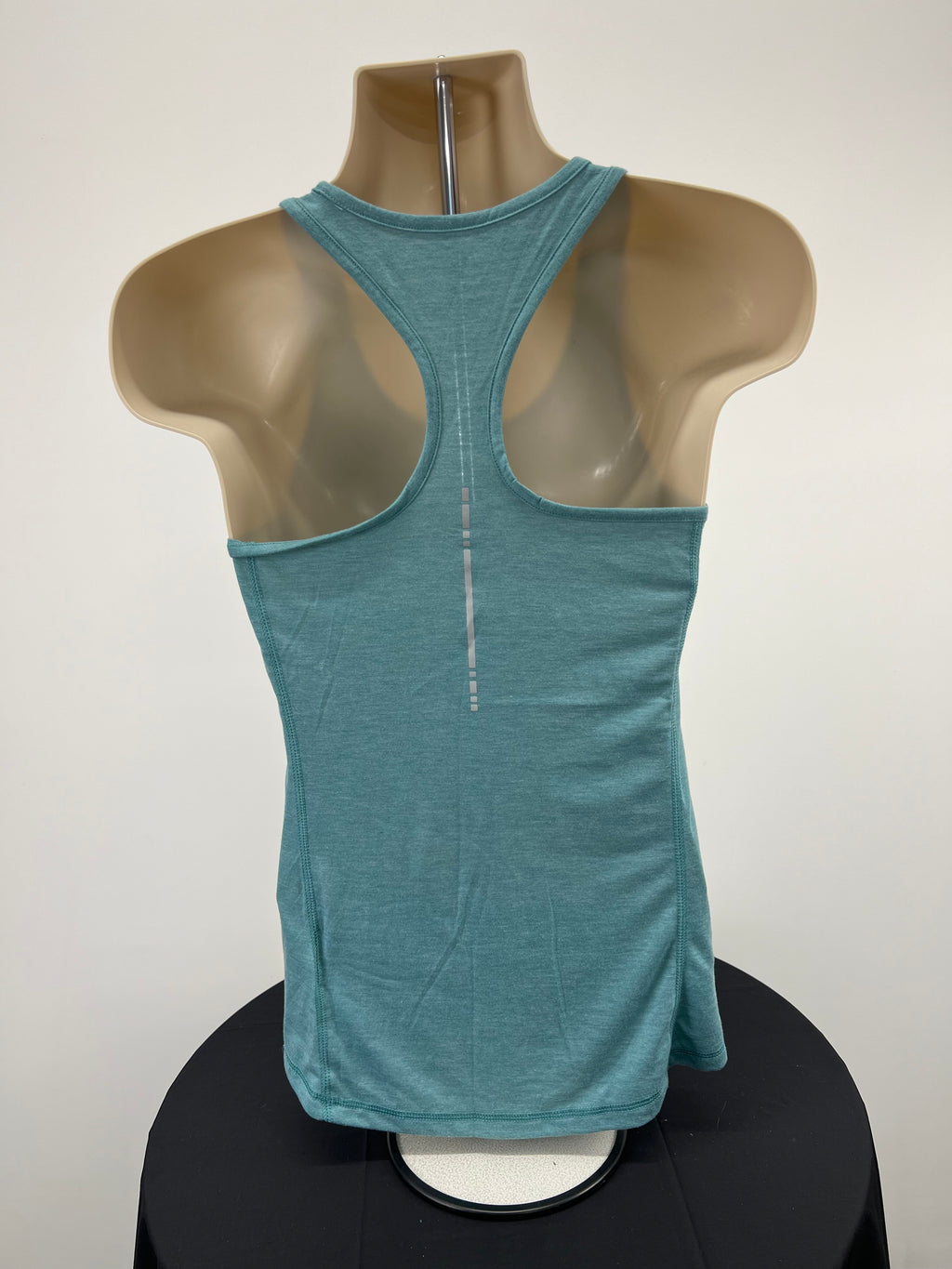 Back view of Asics light green racerback vest top on mannequin