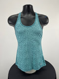 Front view of Nike Dri-FIT slim fit green sports vest with abstract pattern on mannequin