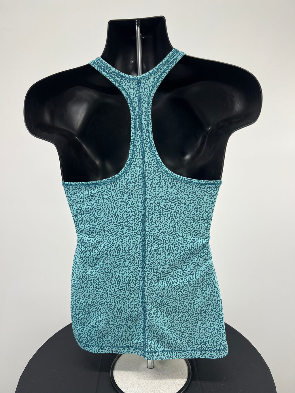 Back view of Nike Dri-FIT slim fit green sports vest showing racerback design on mannequin