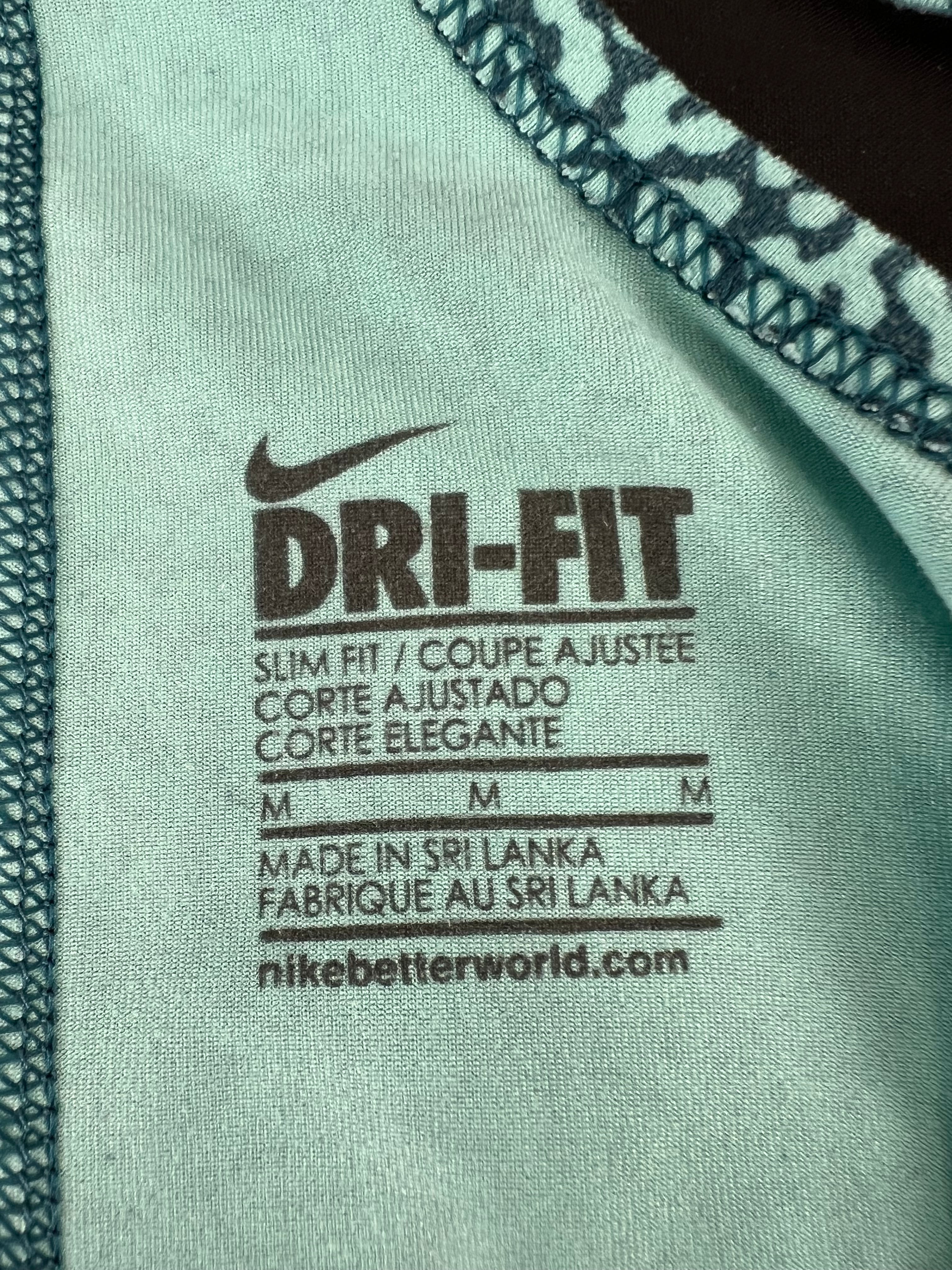 Close-up of Nike Dri-FIT vest fabric label showing size M and made in Sri Lanka