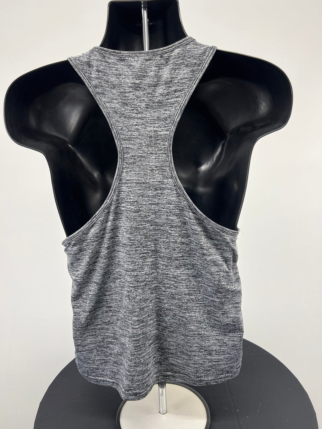Back view of USA Pro grey marl racerback sports vest displayed on black mannequin