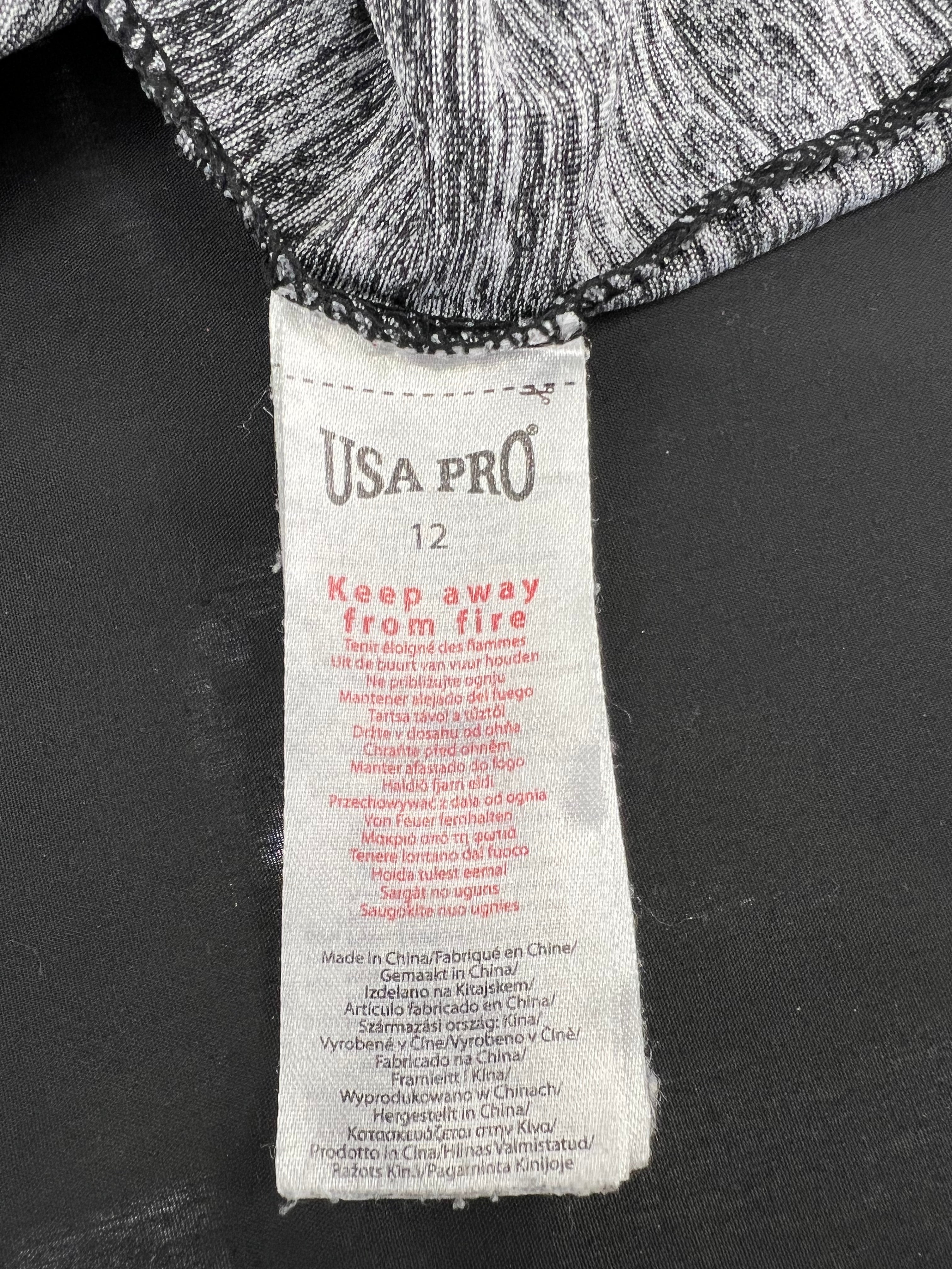 Close-up of USA Pro clothing label inside grey marl sports vest showing size 12 and care instructions