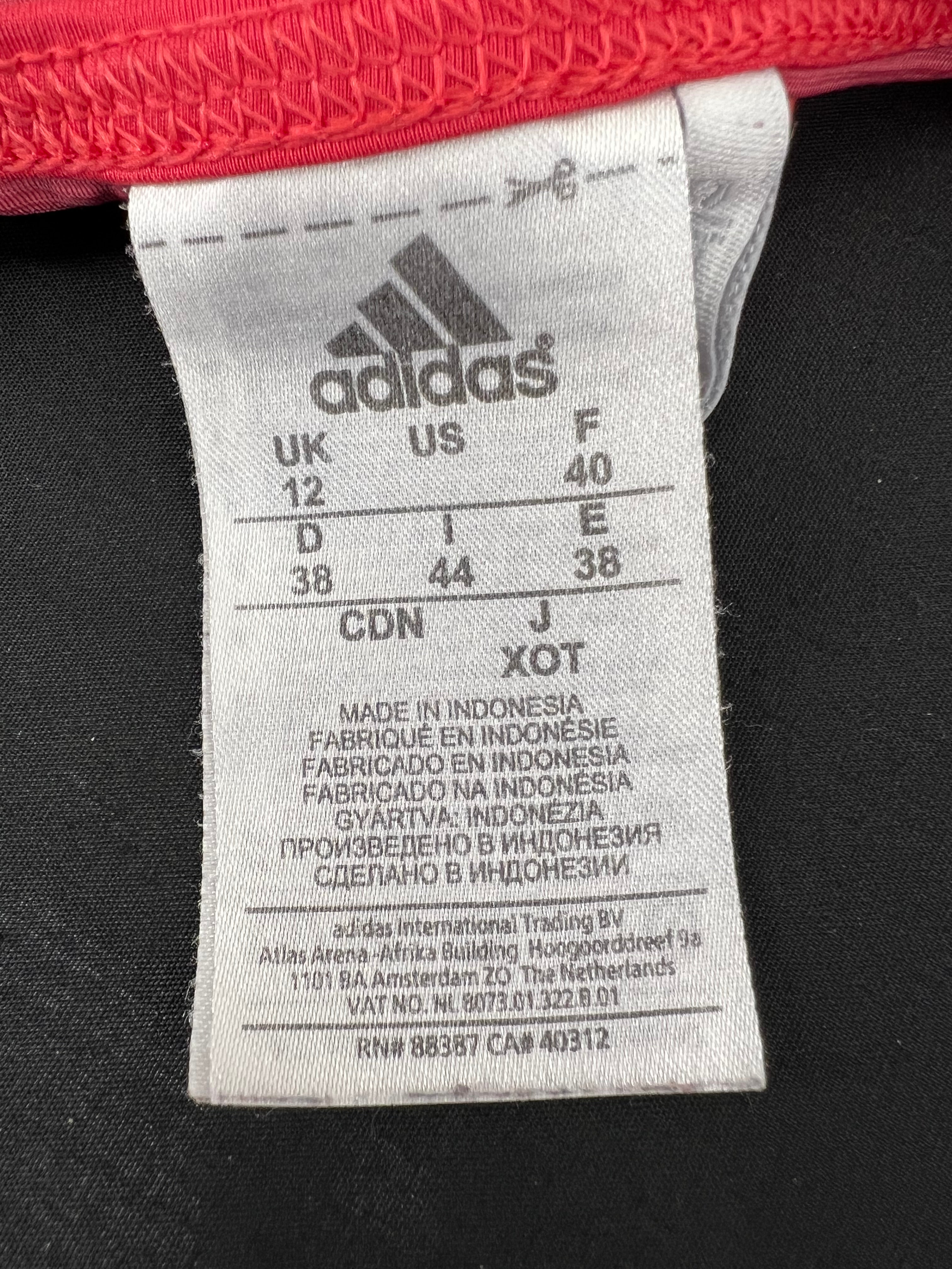Close-up of Adidas size tag indicating UK size 12 and manufacturing details