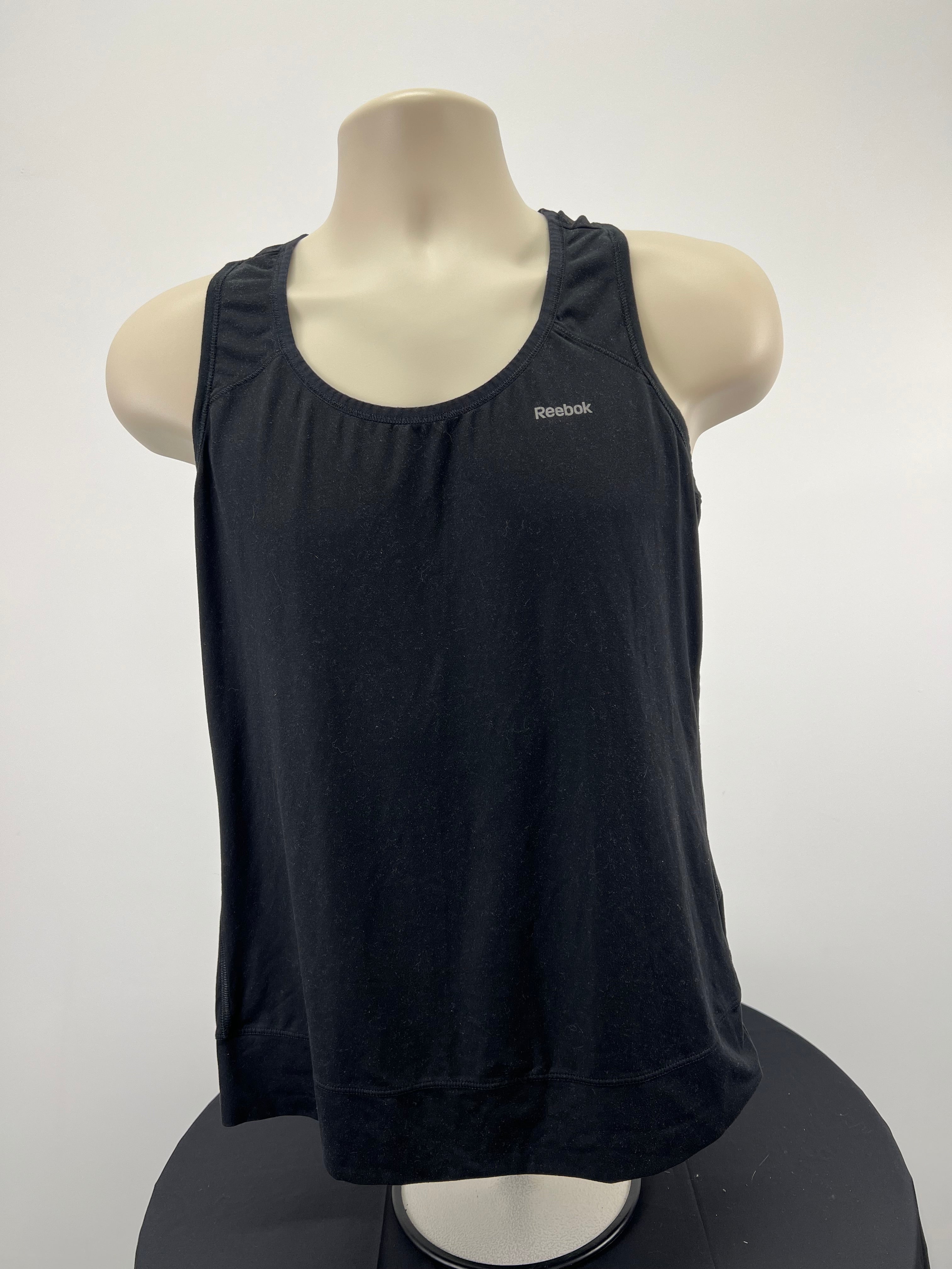 Front view of Reebok black sports vest on mannequin