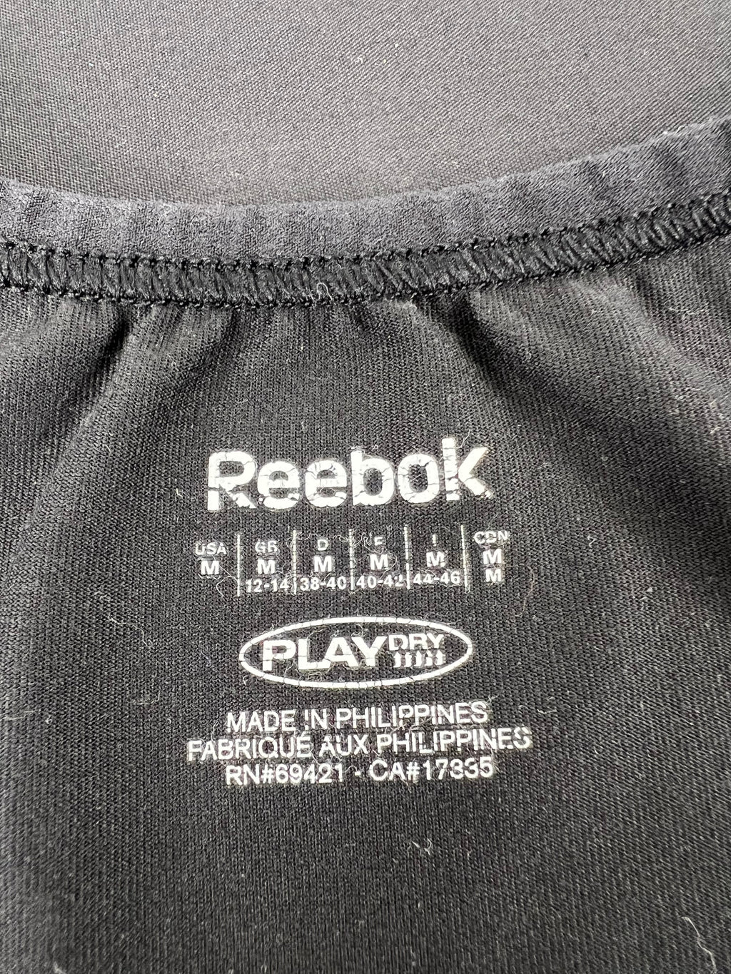 Close-up of internal label showing Reebok PlayDry technology and size information