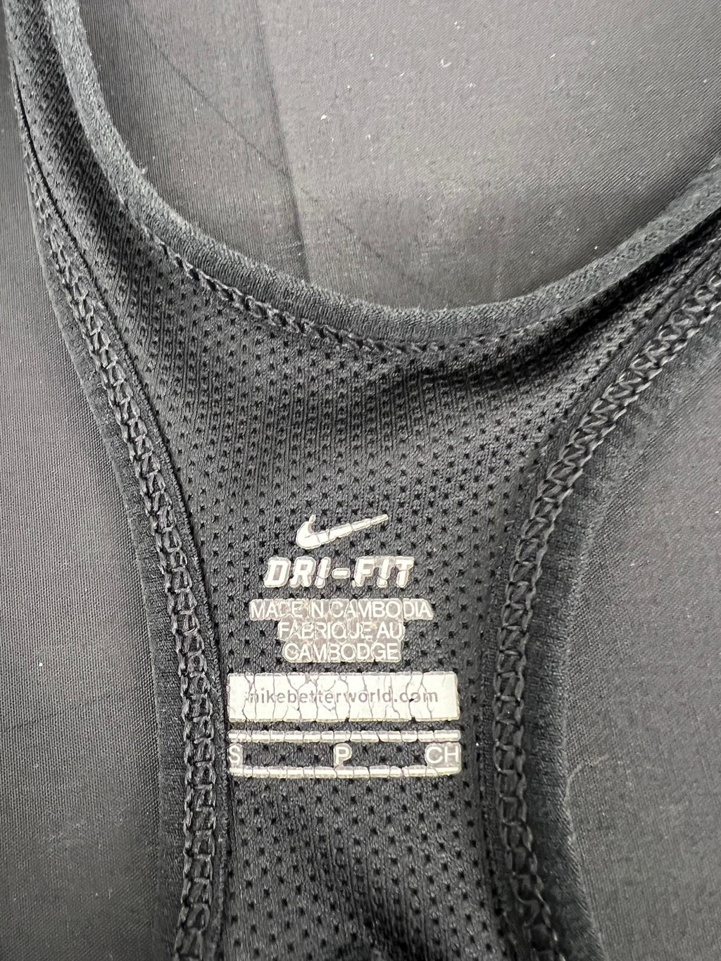 Close-up of internal label and fabric texture showing Nike Dri-FIT branding and size Small