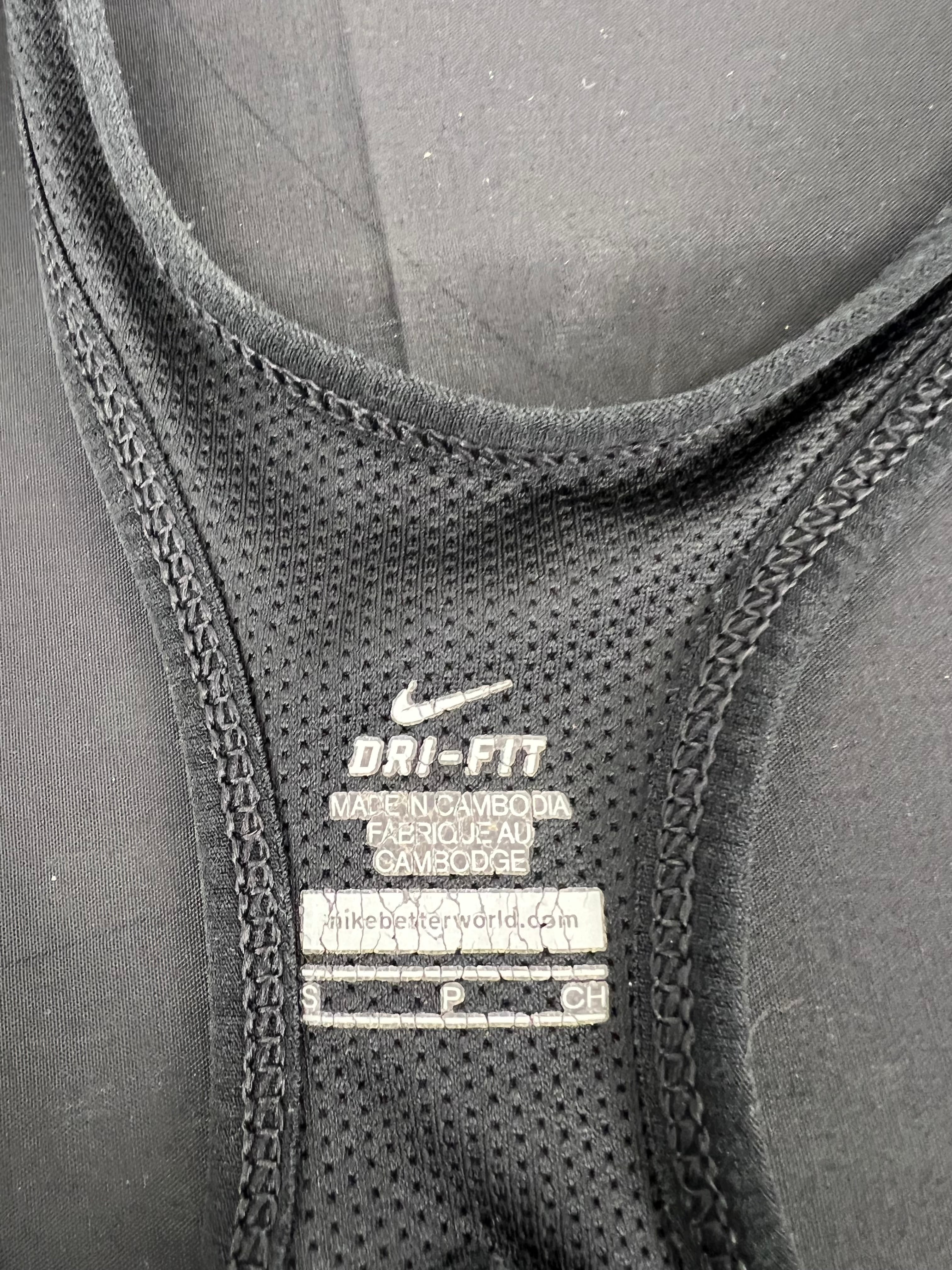Close-up of internal label and fabric texture showing Nike Dri-FIT branding and size Small