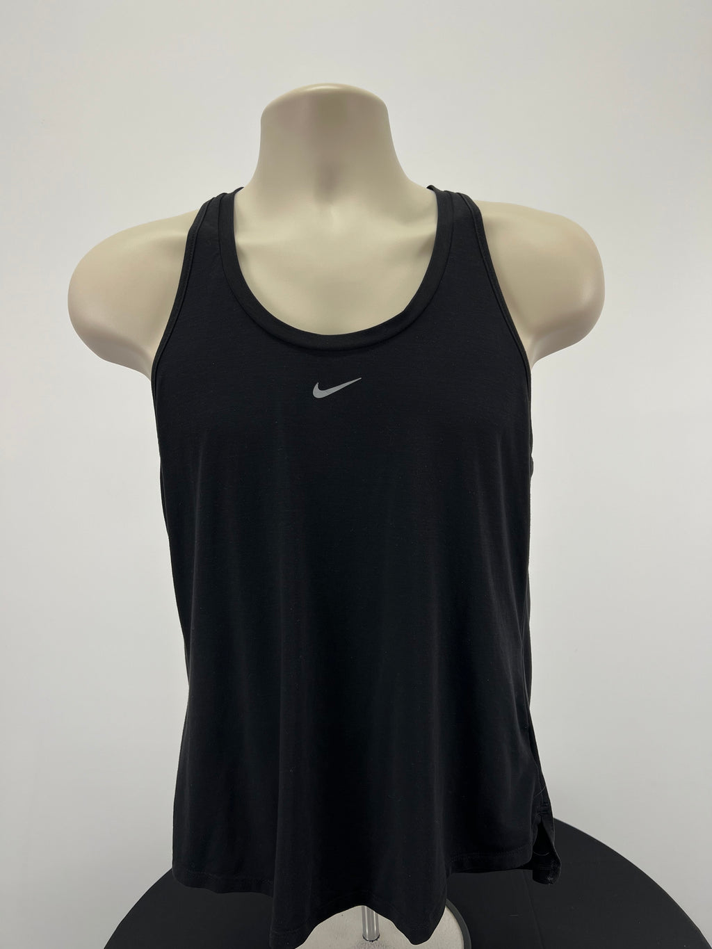 Front view of Nike black training vest with scoop neck and small reflective Nike logo