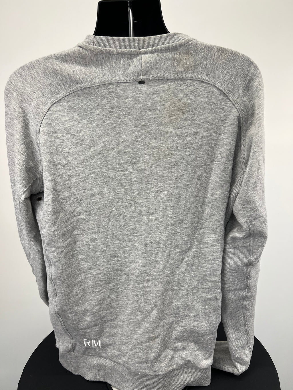 Rear view of BLK Exiles grey sweatshirt with embroidered RM initials on bottom side