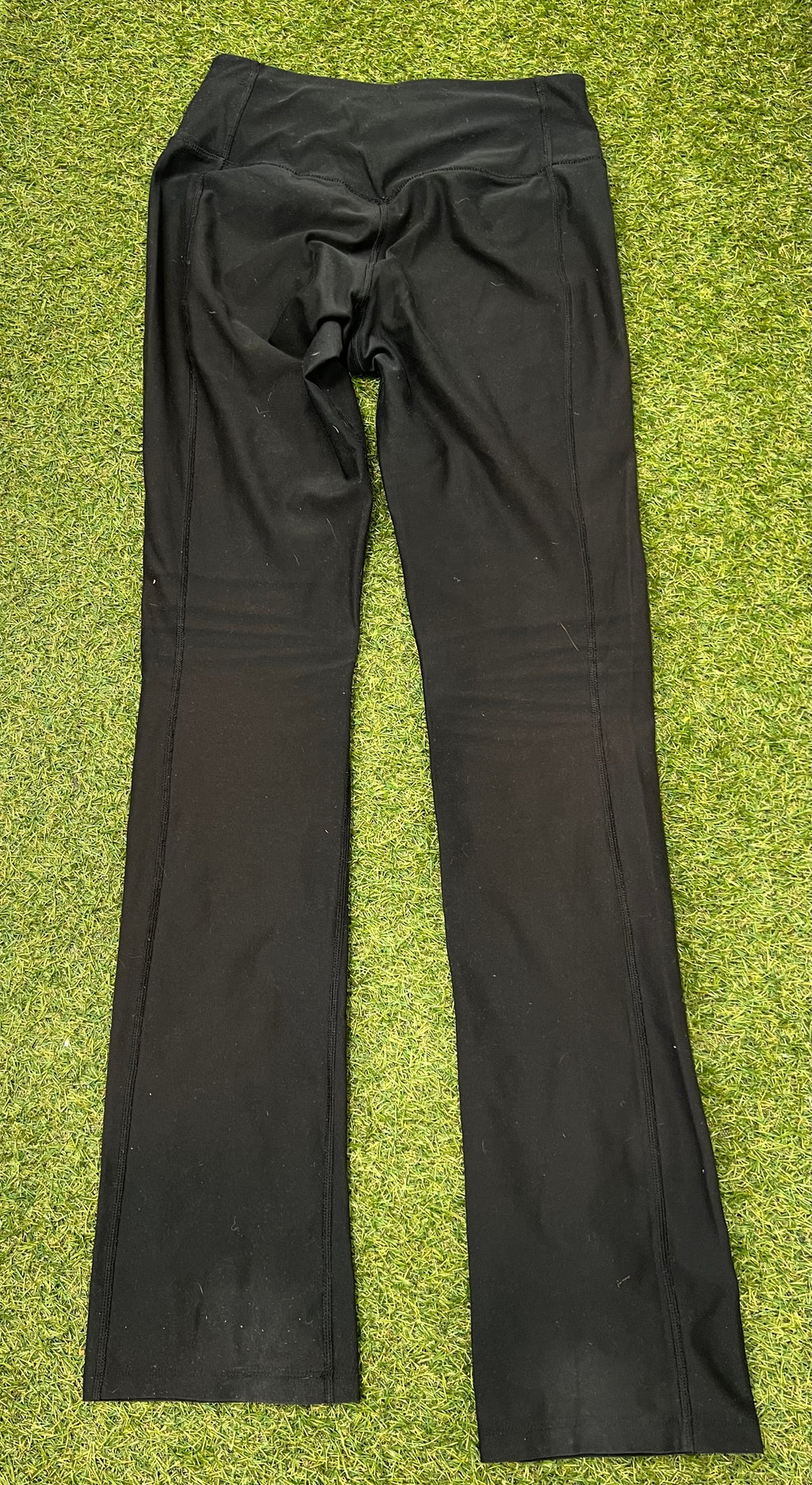 Rear view of women's black Nike Dri-FIT leggings showing stitch details and waistband