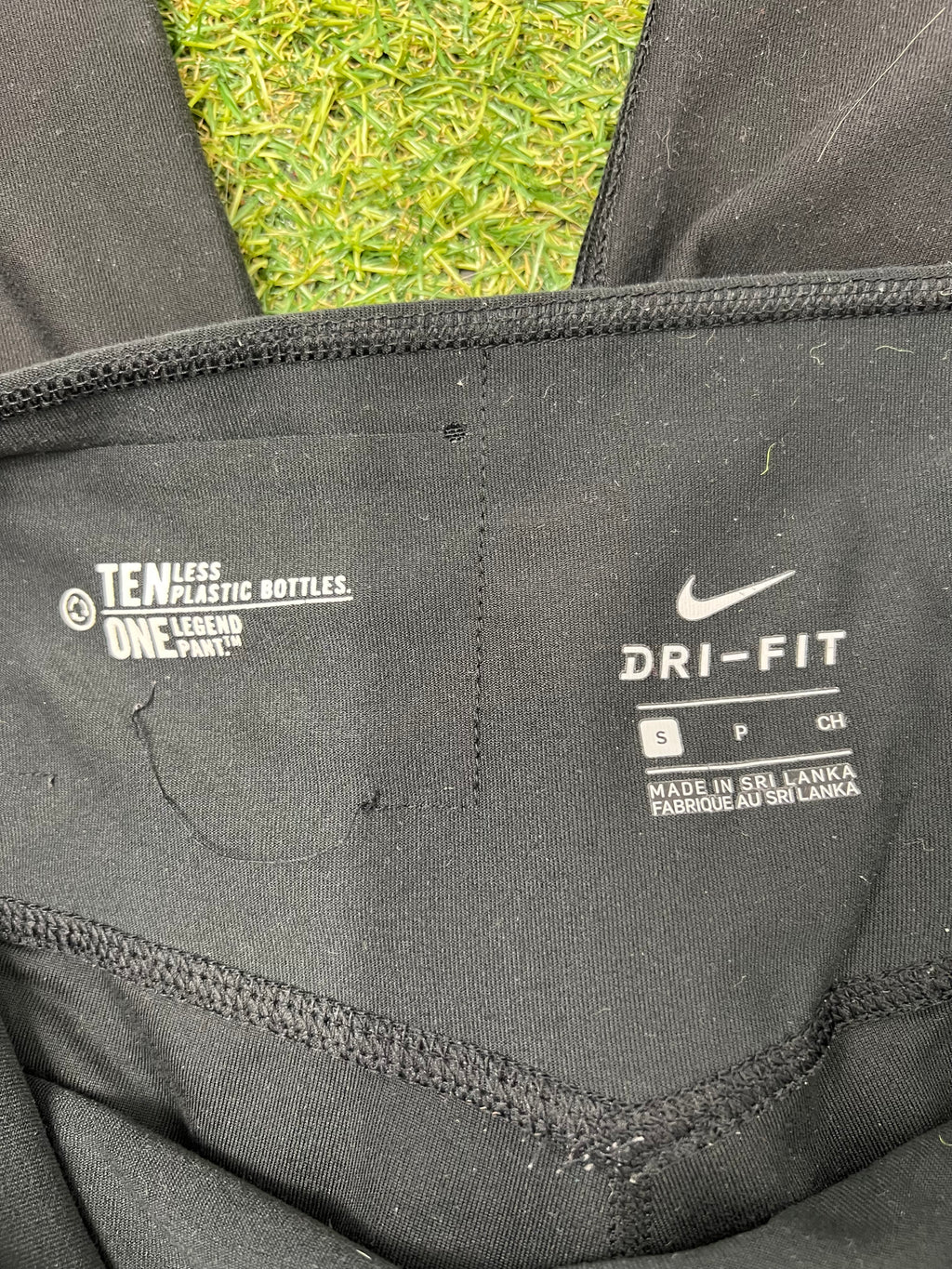 Close-up inside label displaying Nike Dri-FIT technology and size S, made in Sri Lanka