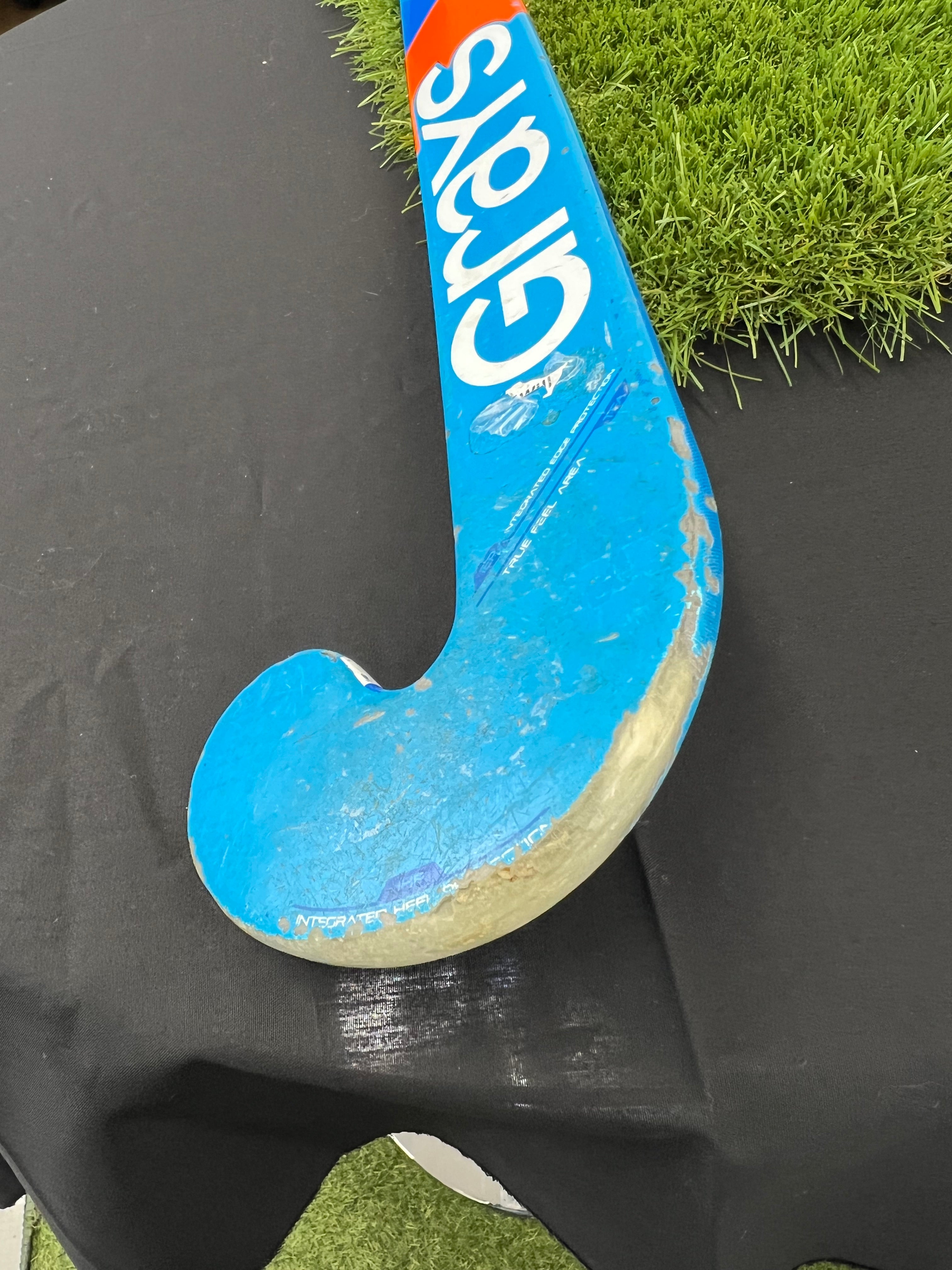 Close-up of worn toe and curved blade tip of Grays hockey stick showing signs of use