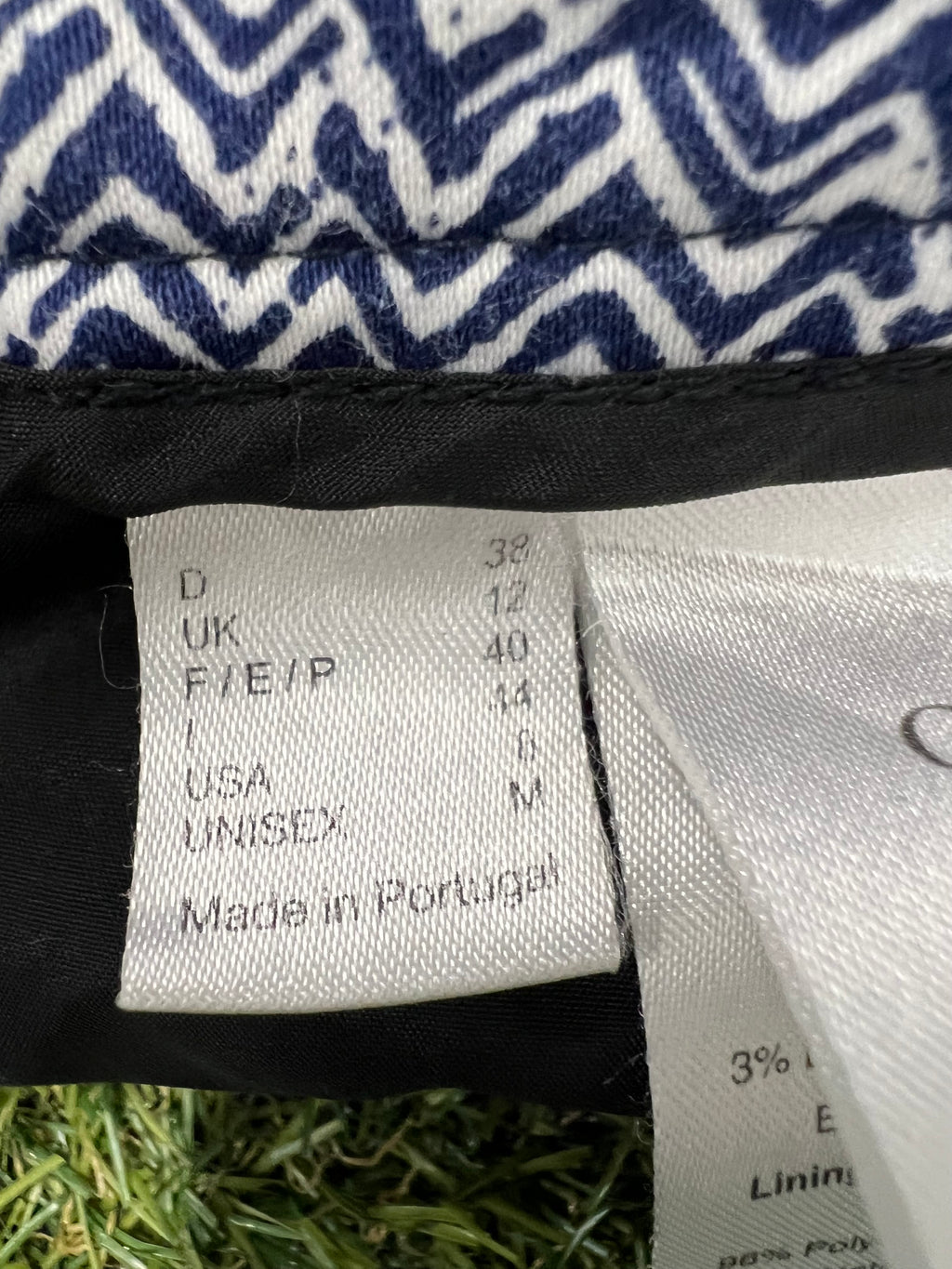 Size tag inside the trousers indicating size UK 12 and made in Portugal