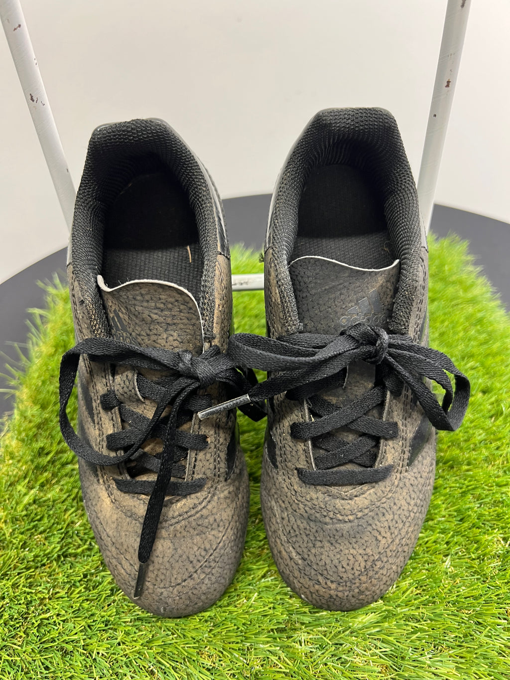 front view of kids adidas black football boots size 13 with laces tied