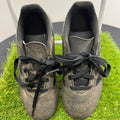 Top view of adidas black kids football boots with laces on artificial grass