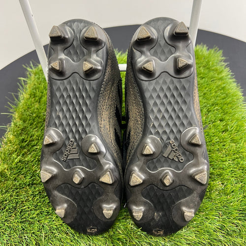 Sole view showing moulded stud pattern and adidas logo on football boots