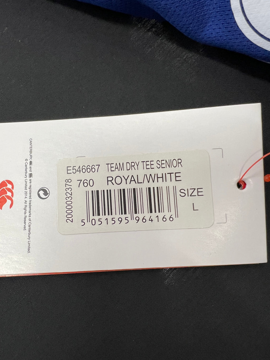 Close-up of size tag on Men’s Canterbury team dry tee showing product code, colour royal/white and size L