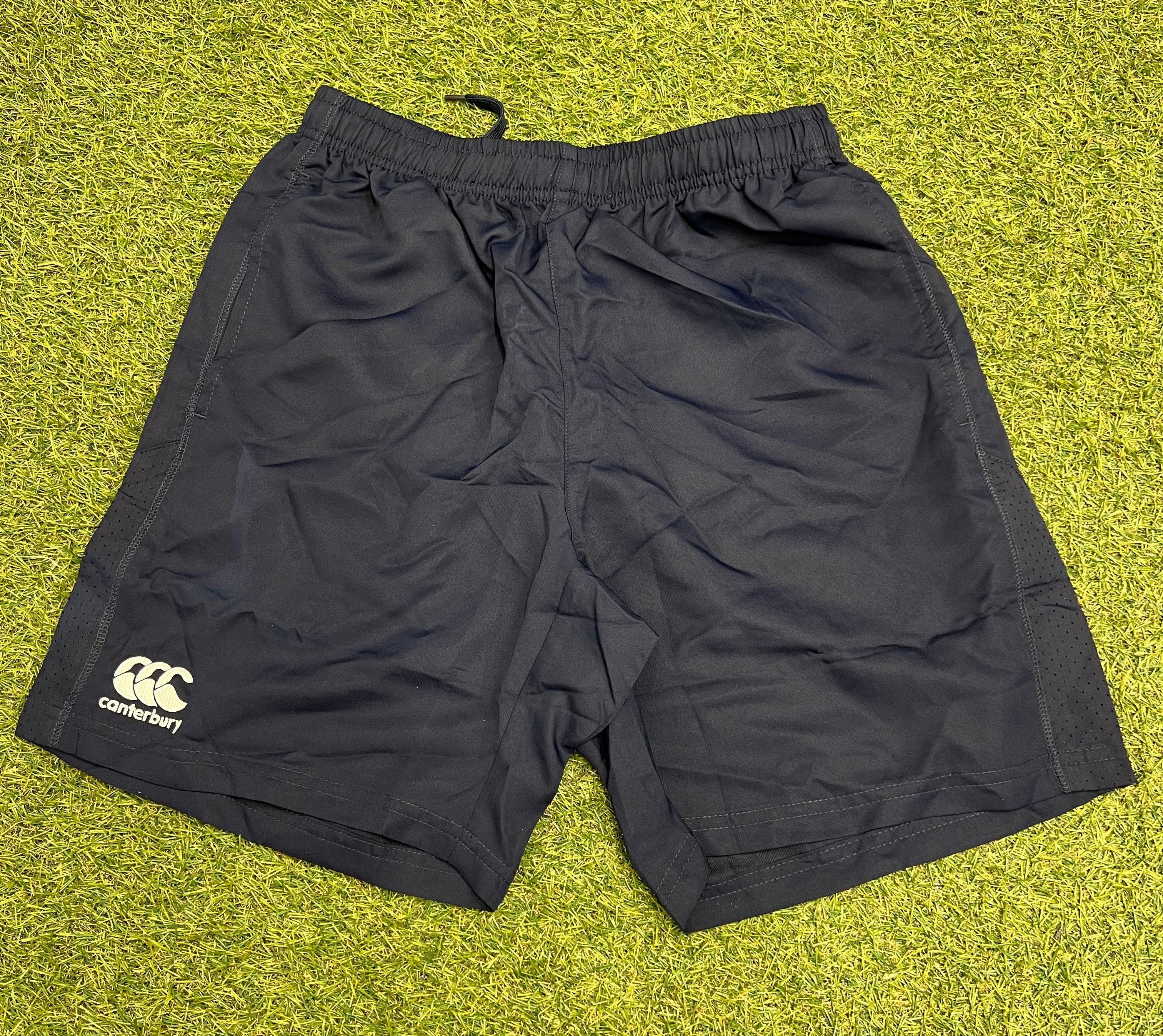 Front view of navy Canterbury team shorts with elastic waist and Canterbury logo on left leg