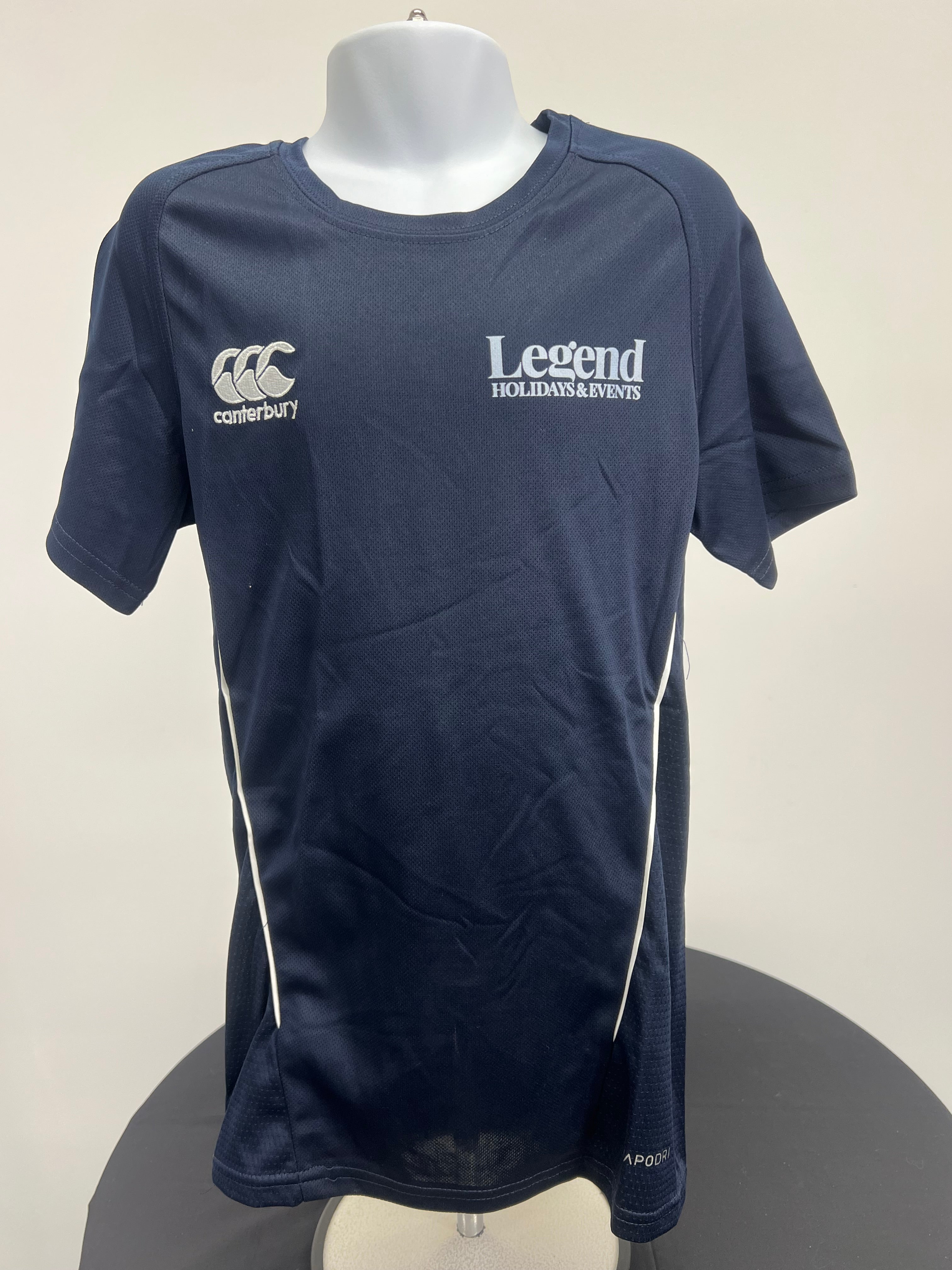 Front view of navy kids Canterbury team dry tee with Canterbury and Legend Holidays & Events logos