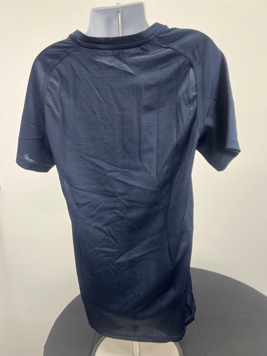 Rear view of Kids Canterbury team dry tee in navy showing breathable fabric texture