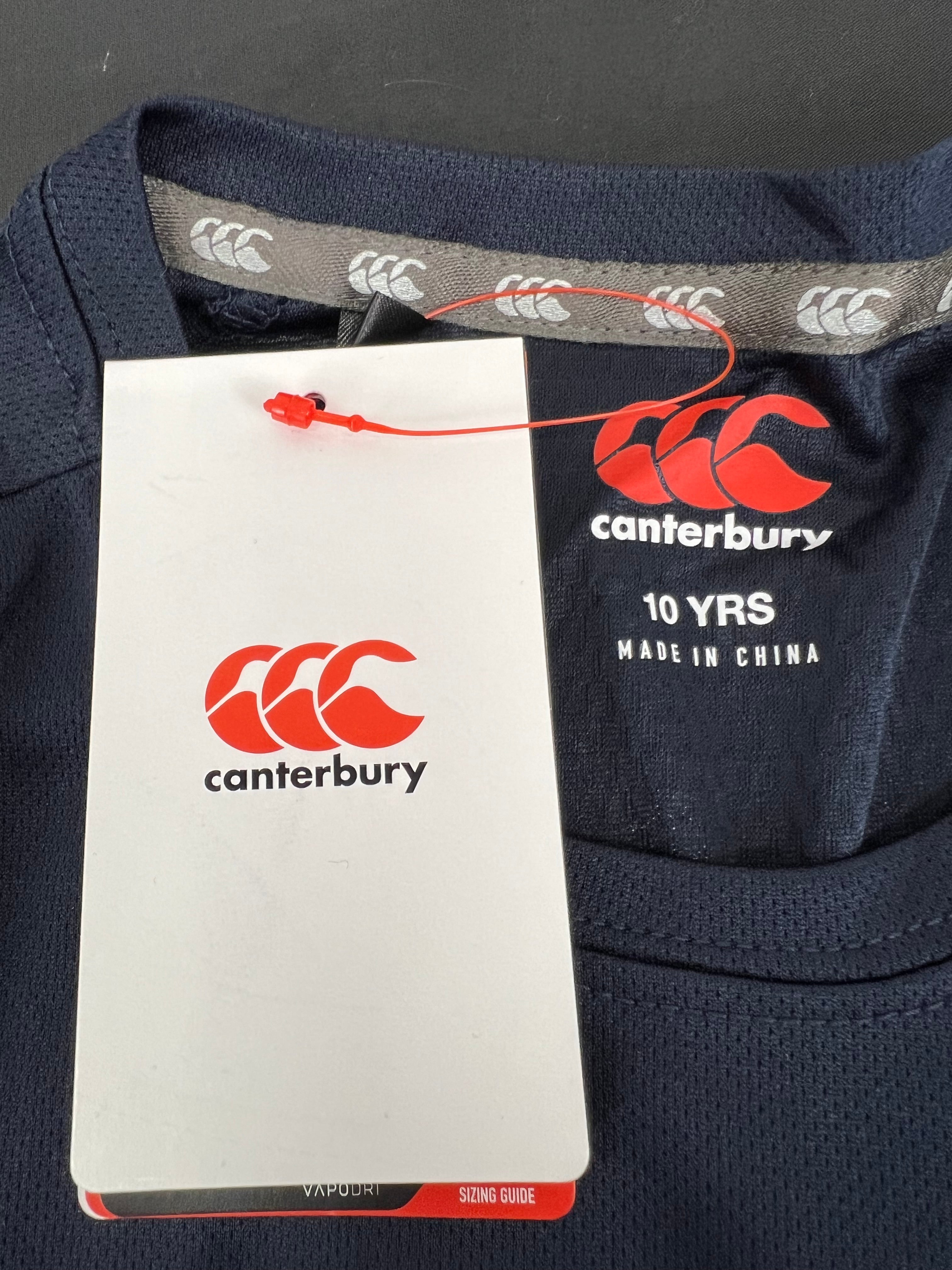 Close-up of size tag inside Kids Canterbury navy dry tee showing age 10 and brand logo