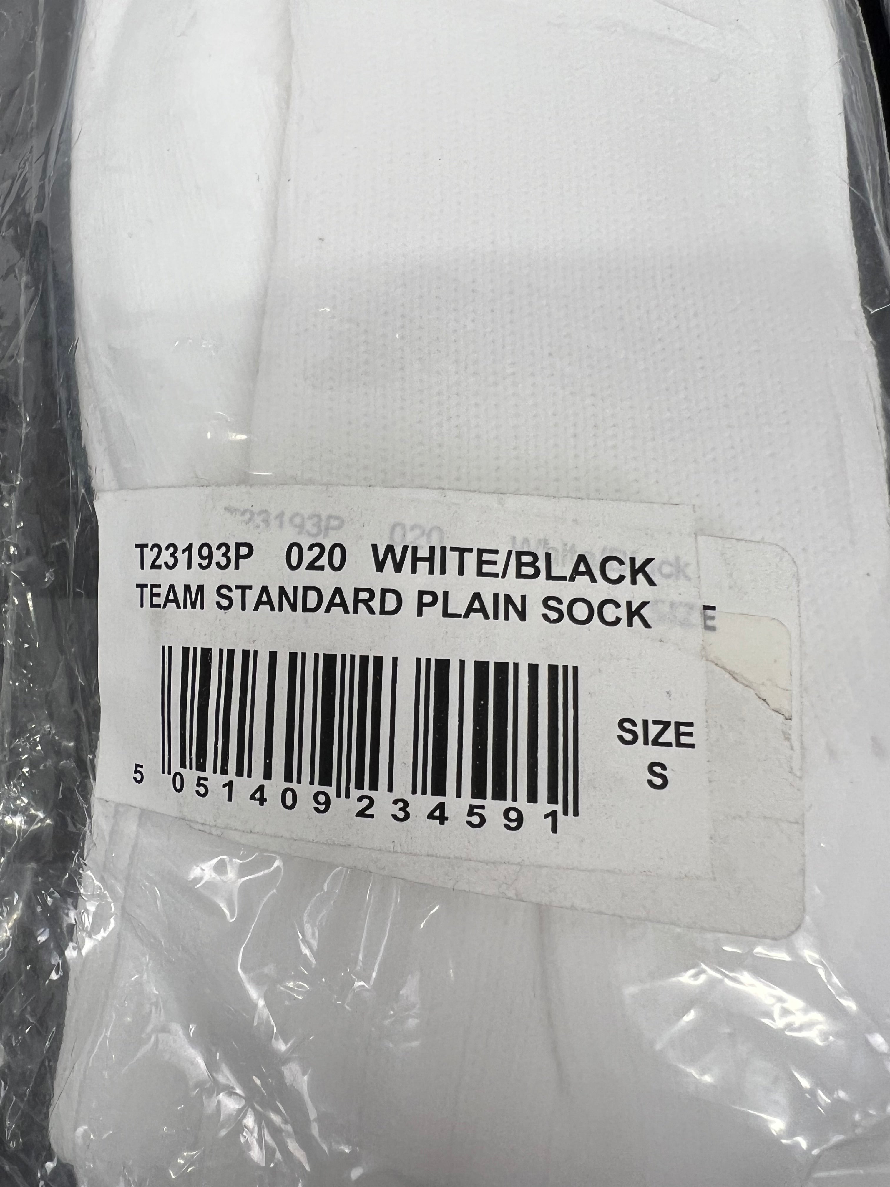 Close-up of packaging label on Canterbury white socks indicating team standard plain sock size S