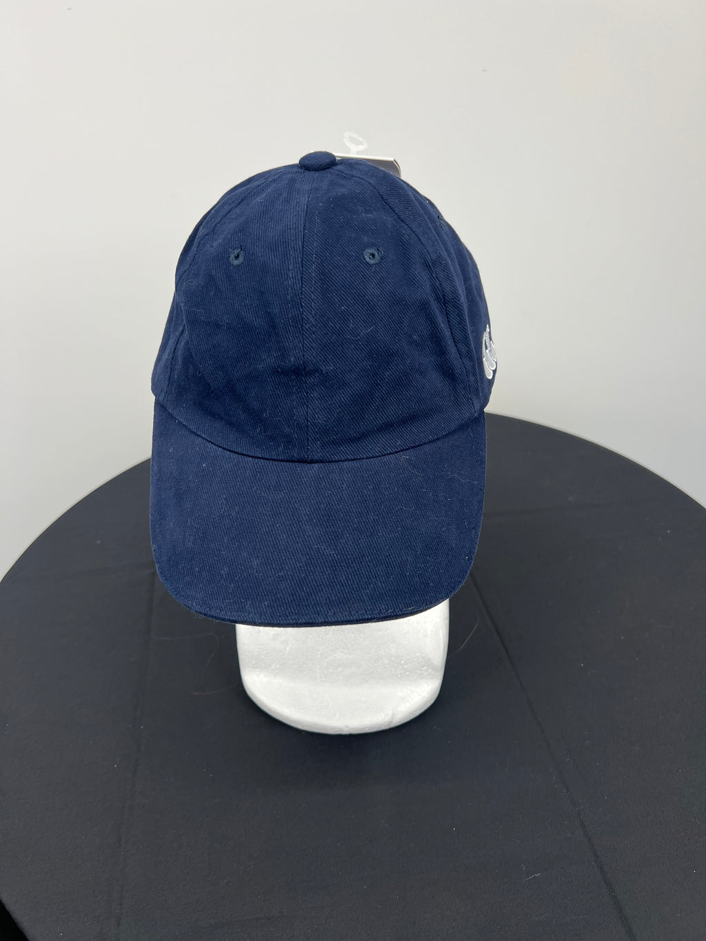Front view of Canterbury navy cap with stitched ventilation eyelets and curved brim
