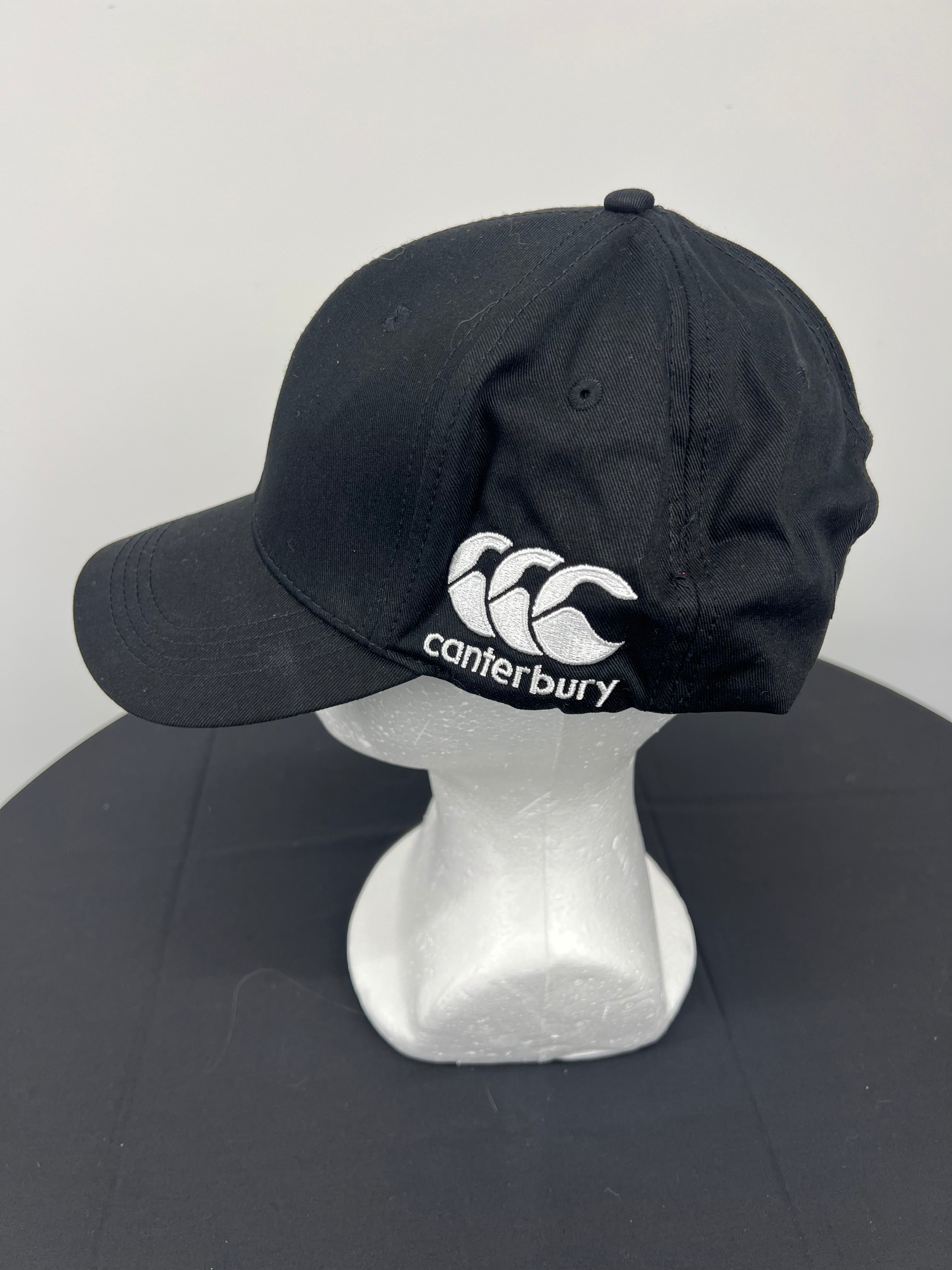 Side view showing embroidered Canterbury logo on black cap