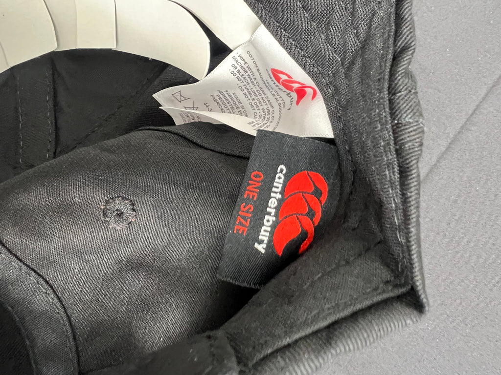 Inside view of Canterbury cap showing brand label and one size tag