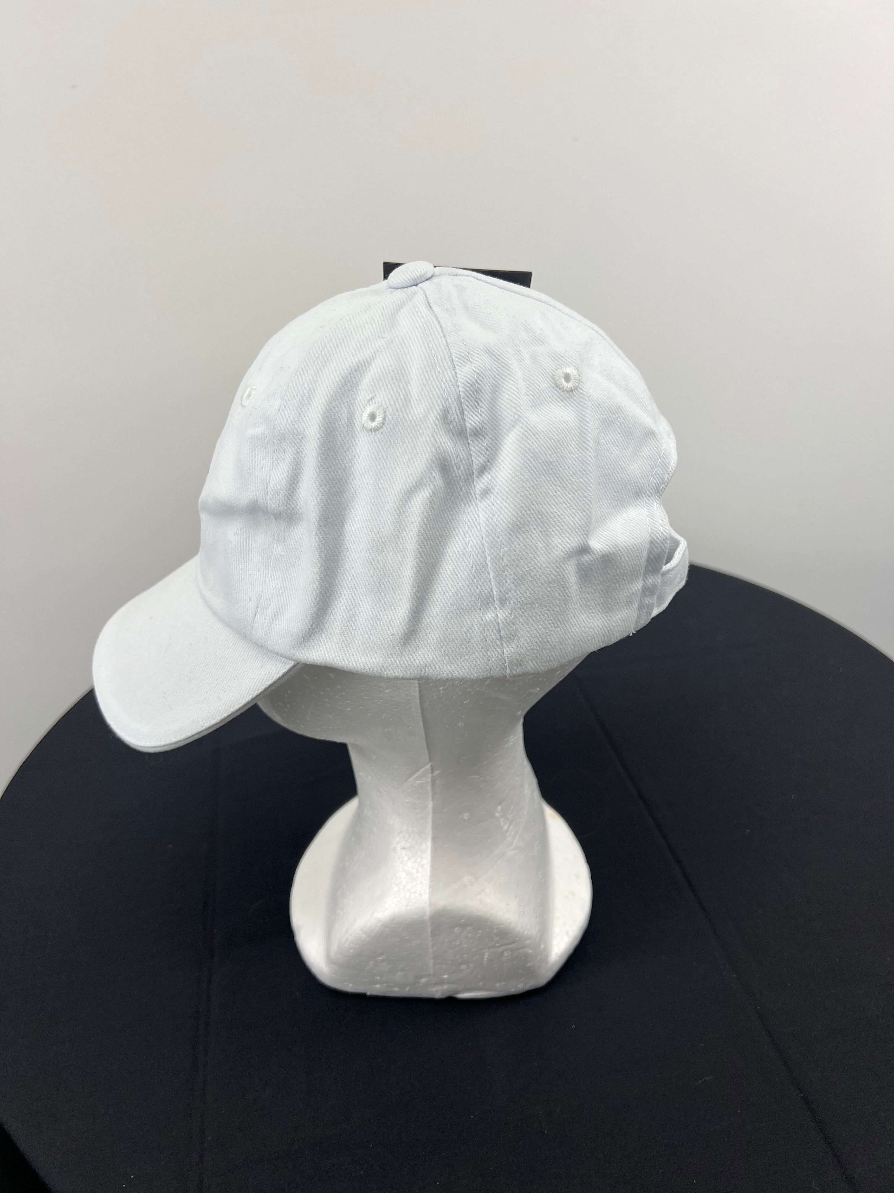 Left side view of white Canterbury cap showing side ventilation eyelets