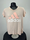 Front view of Adidas pink t-shirt with coral logo and white lettering on black mannequin