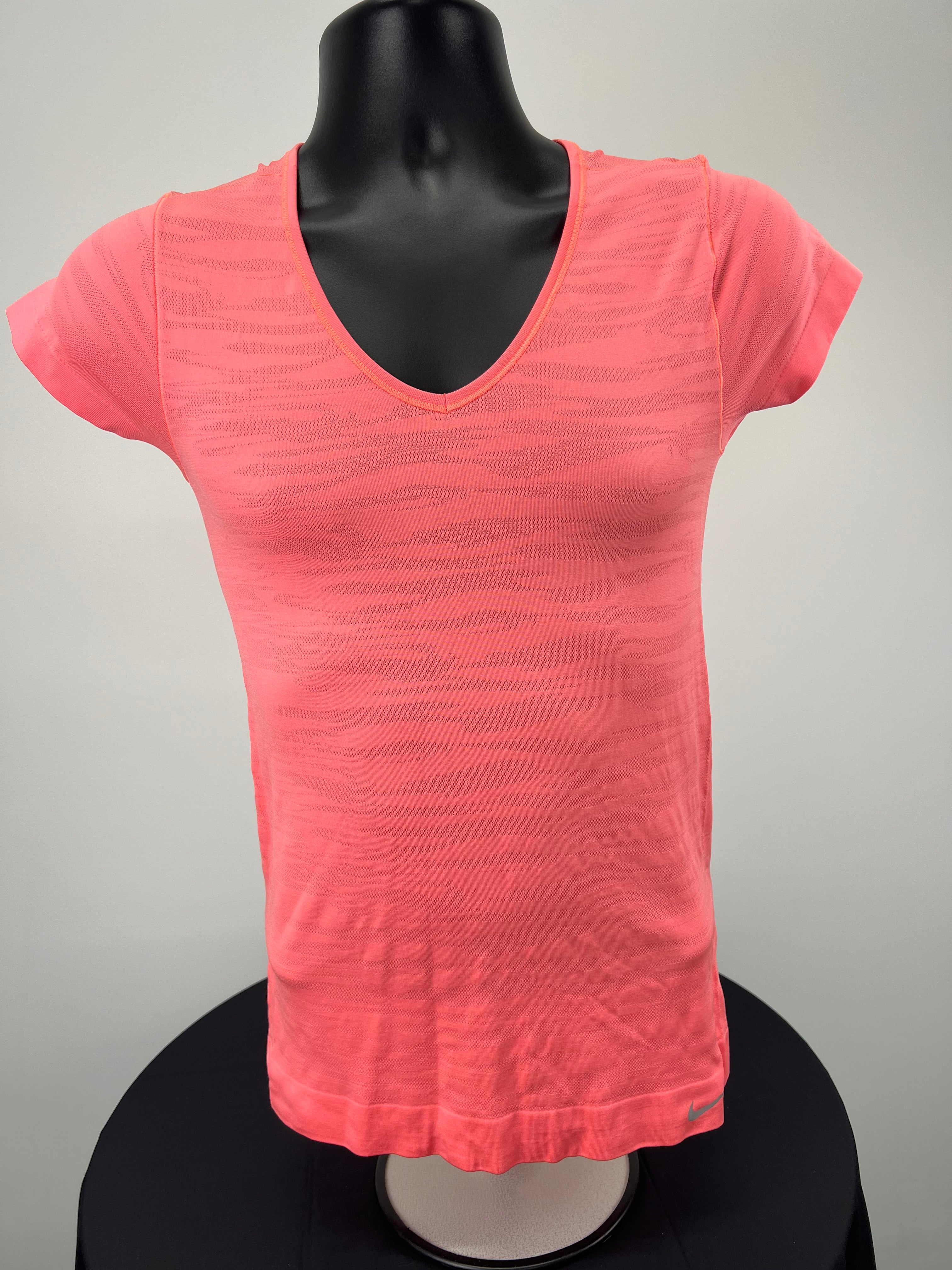 Front view of Nike orange Dri-FIT V-neck T-shirt on mannequin