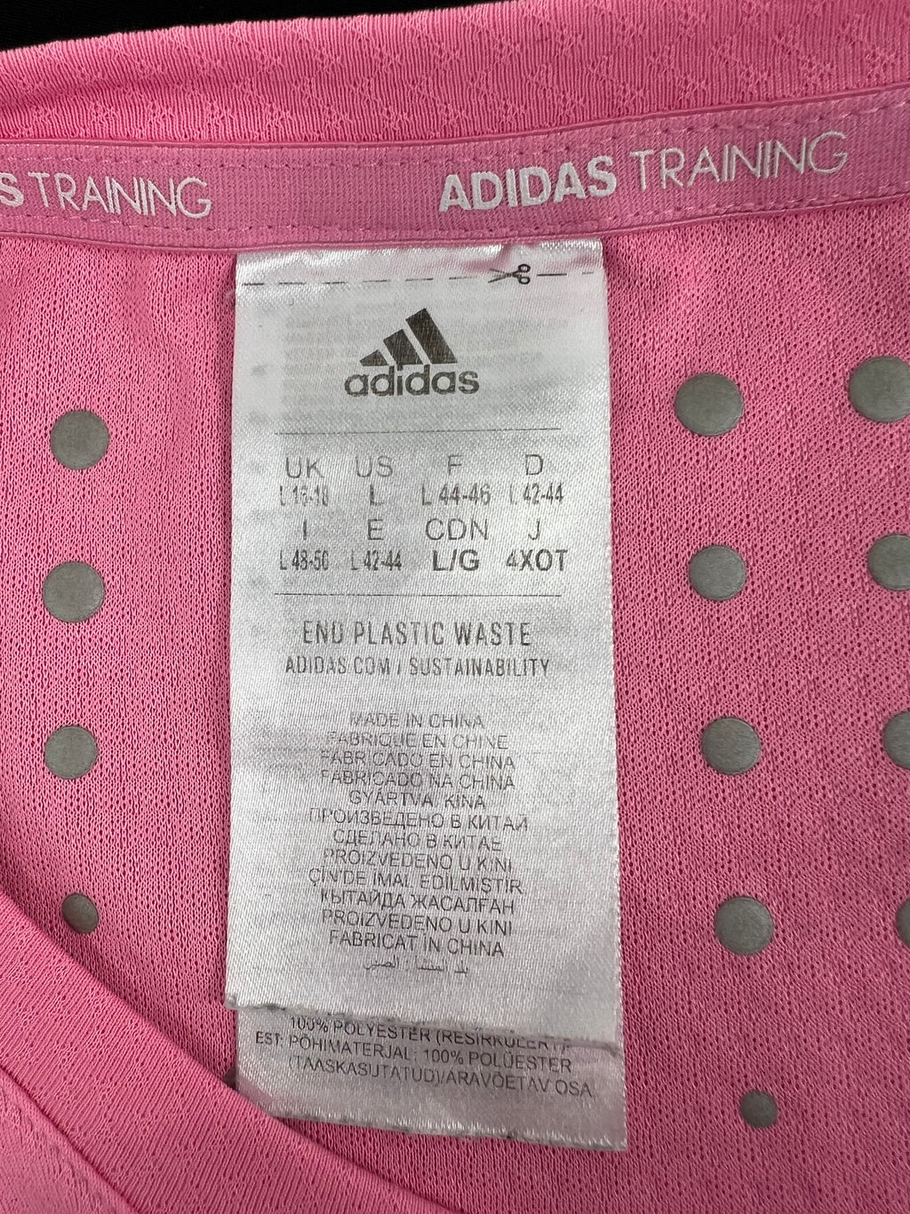 Close-up of Adidas training t-shirt label showing size and material details