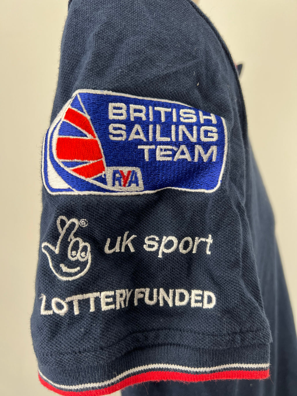 Side close-up of sleeve showing British Sailing Team, uk sport lottery funded embroidered logos