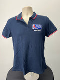 Front view of navy blue Musto British Sailing Team polo shirt with embroidered British Sailing Team and Volvo logos