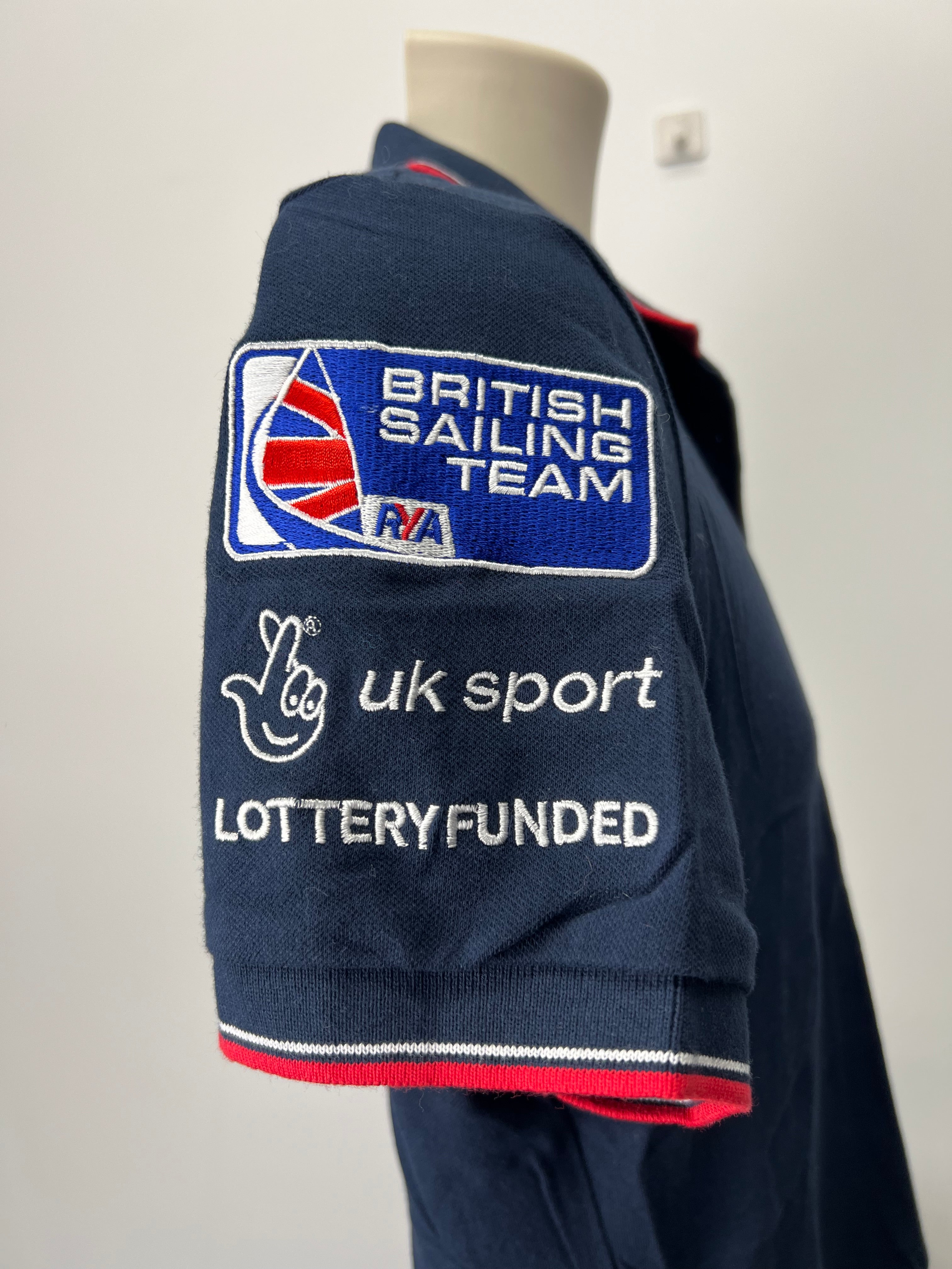 Close-up of opposite sleeve with embroidered British Sailing Team, UK Sport, and Lottery Funded logos