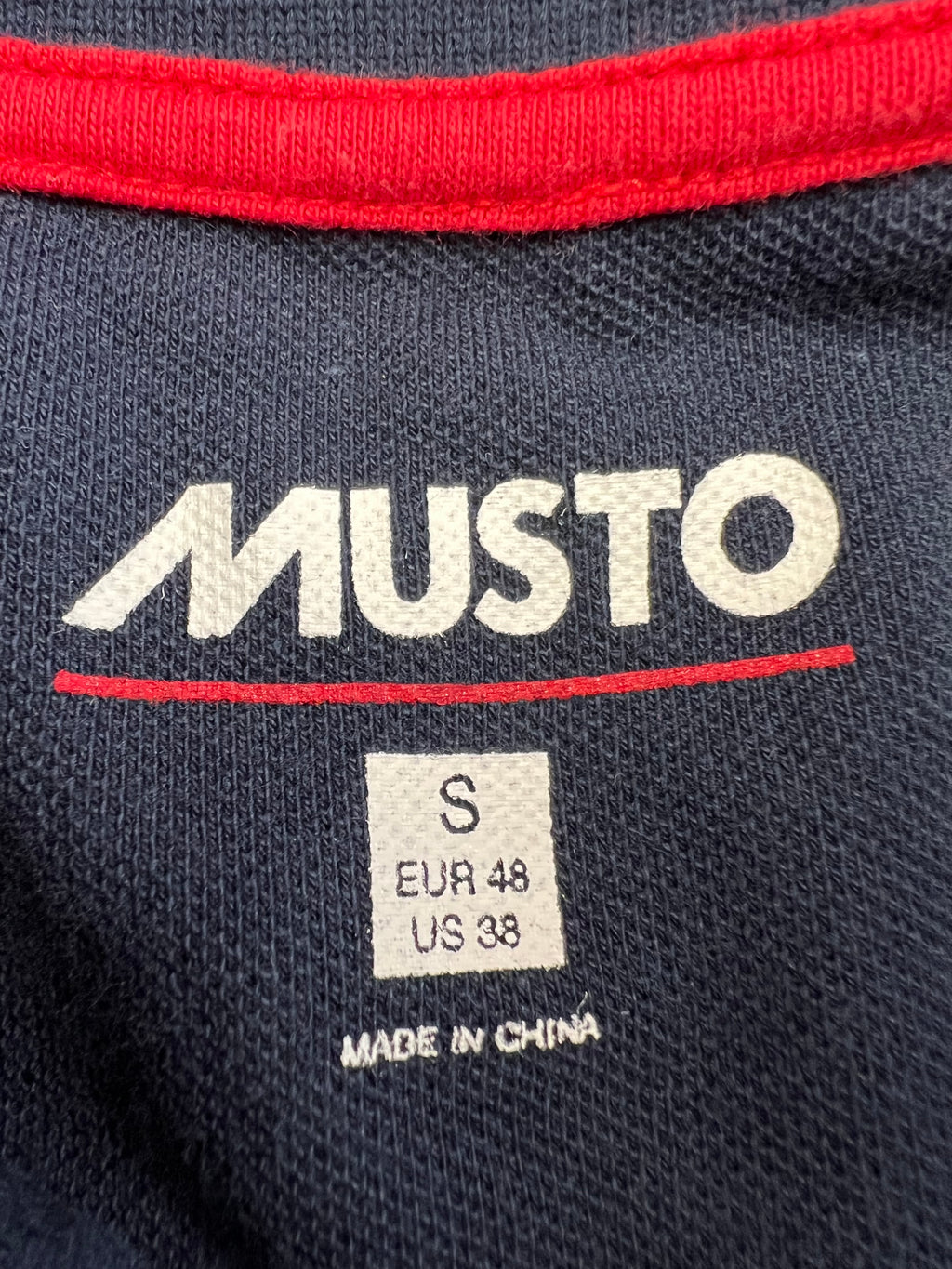 Inside neck label showing 'MUSTO', size Small with EU and US sizing, made in China