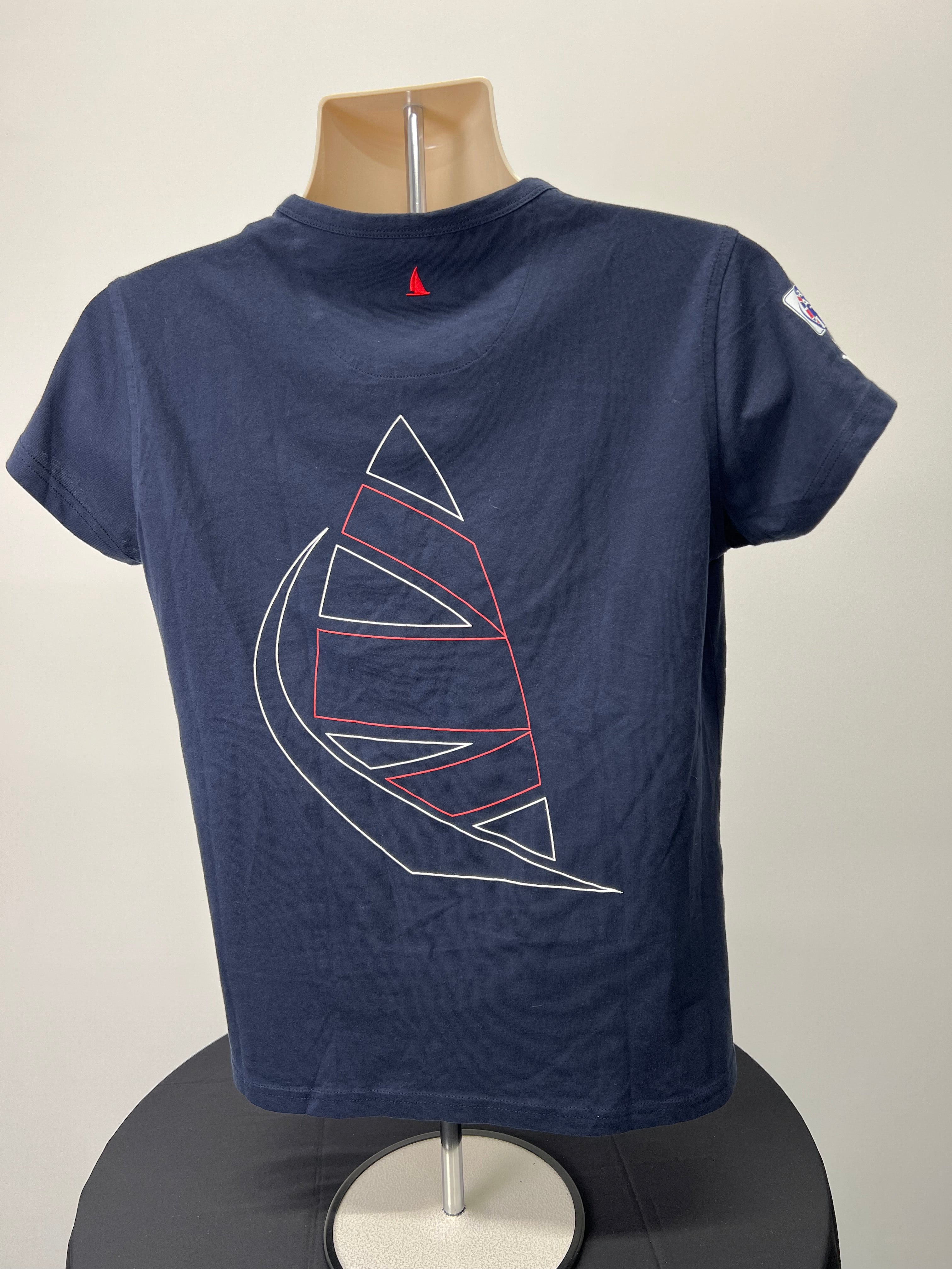 Back view of navy blue t-shirt showing large outlined sail graphic and small red sail embroidered at neckline