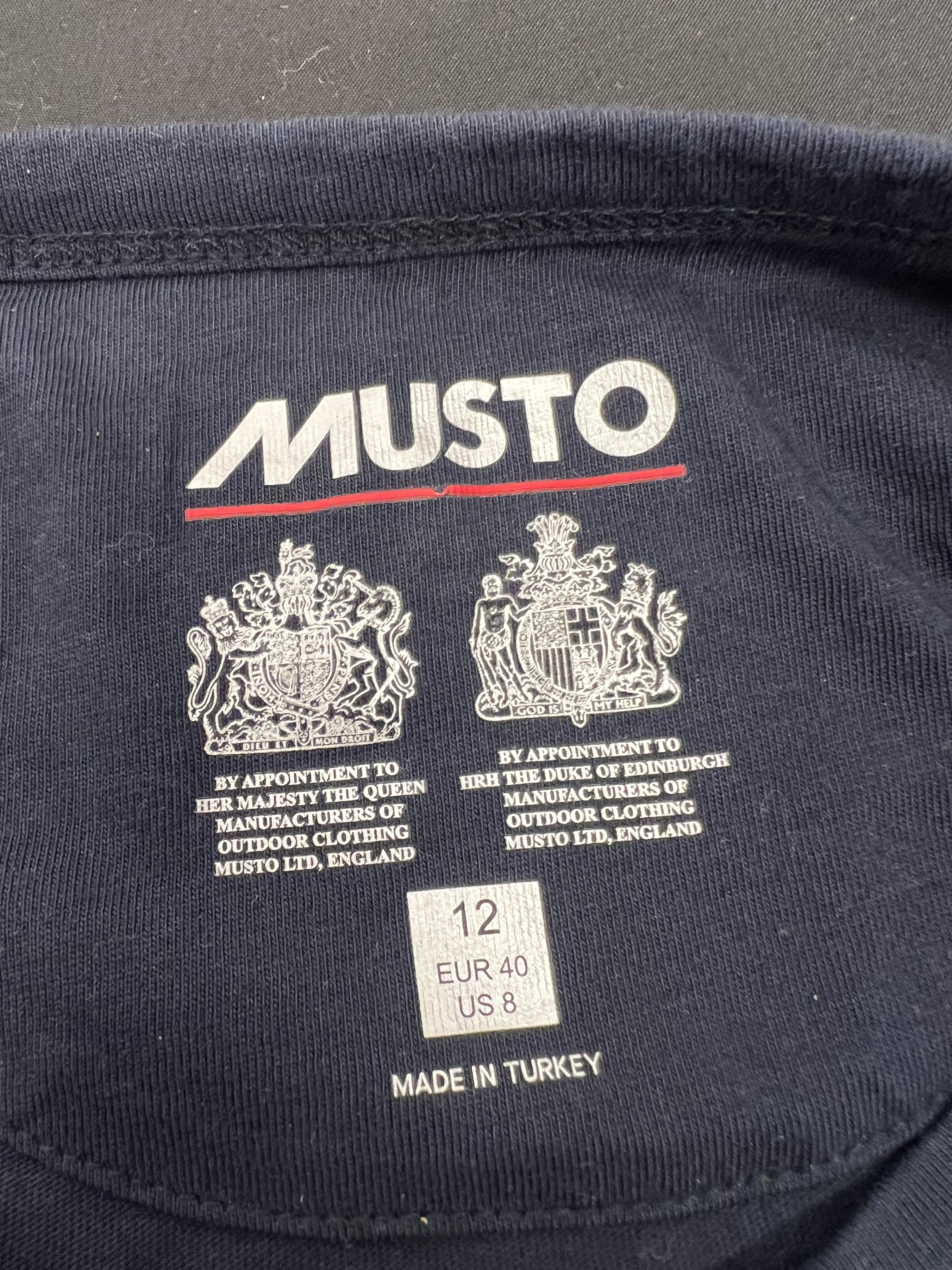 Interior neck label of Musto t-shirt showing royal appointments and size label 12, made in Turkey