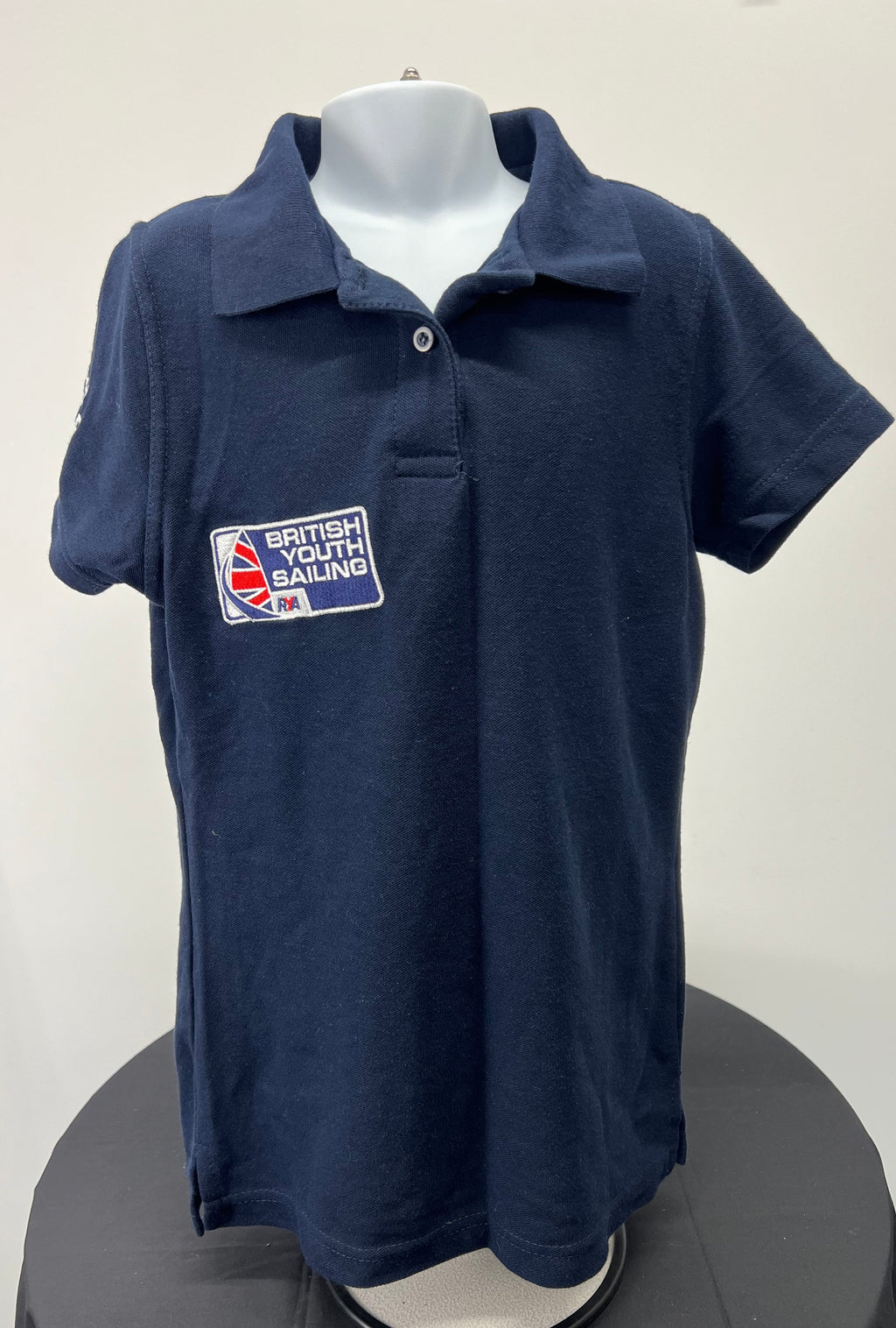 Front view of navy British Youth Sailing polo shirt with embroidered logo on chest
