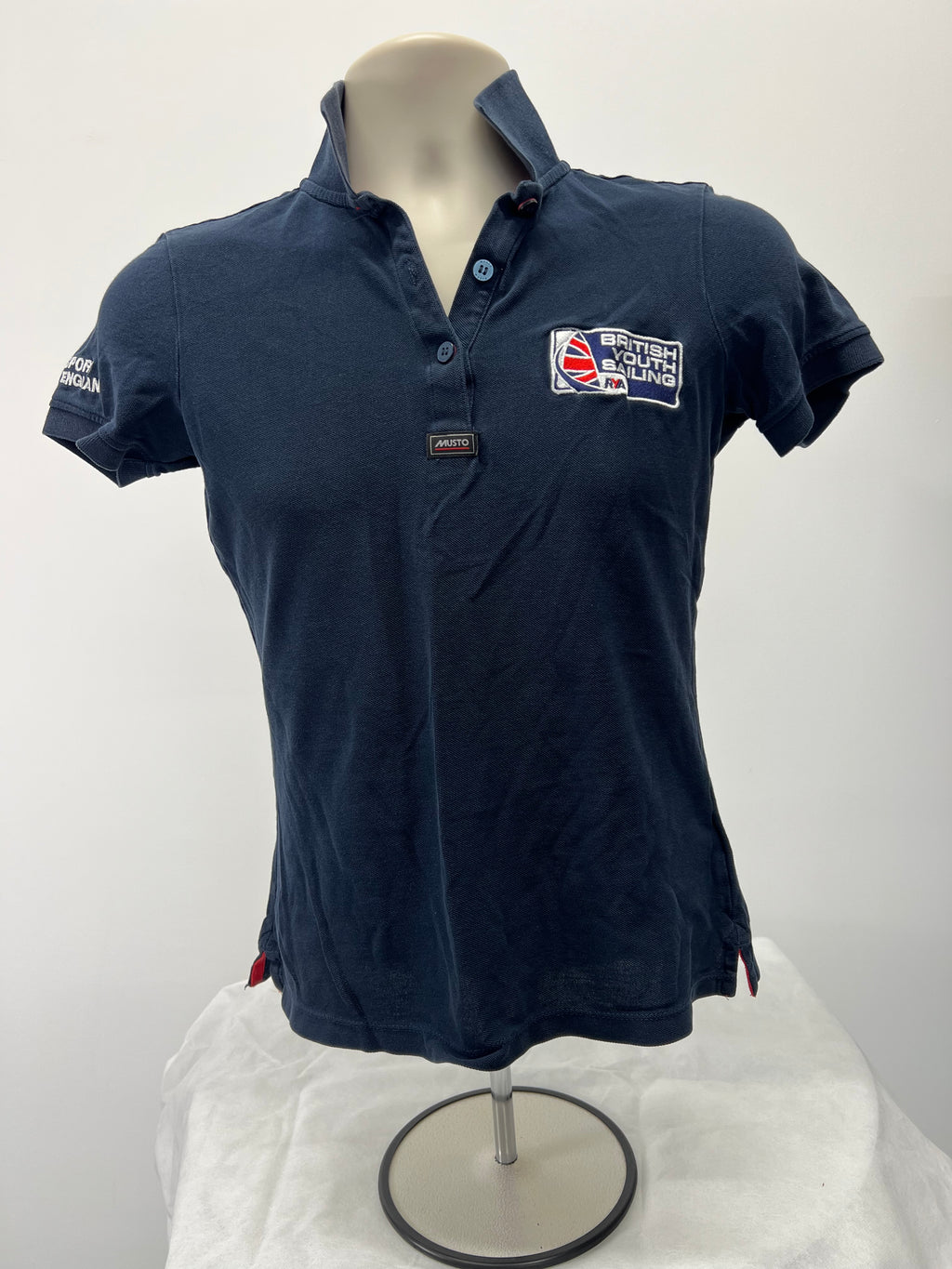 Front view of British Youth Sailing navy polo shirt with embroidered logo and button collar