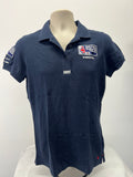 Front view of navy Musto British Sailing Team polo shirt with collar and embroidered chest logos